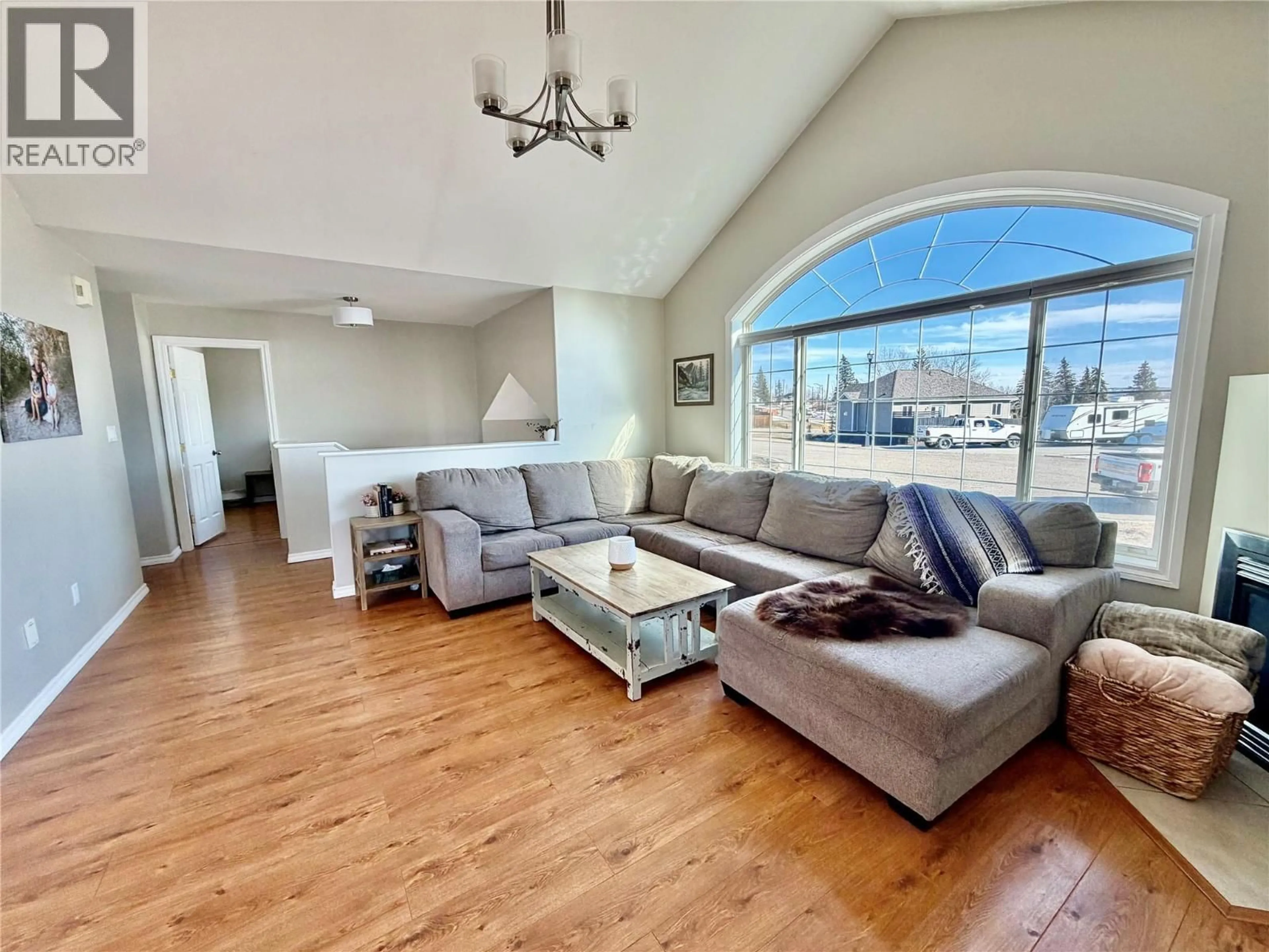 Living room with furniture, wood/laminate floor for 1904 91 AVENUE, Dawson Creek British Columbia V1G4E3
