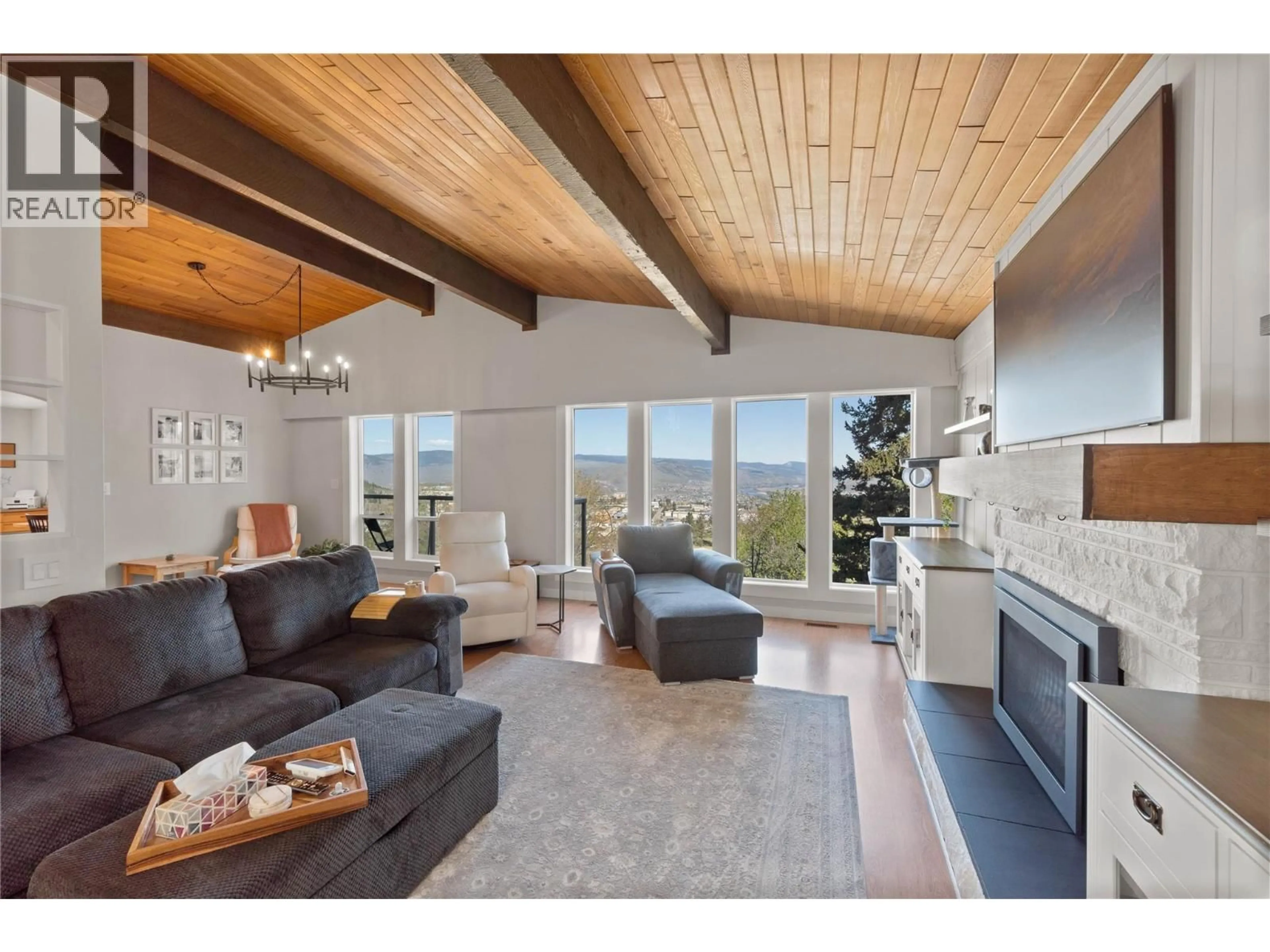 Living room with furniture, wood/laminate floor for 890 GLENEAGLES DRIVE, Kamloops British Columbia V2E1K3