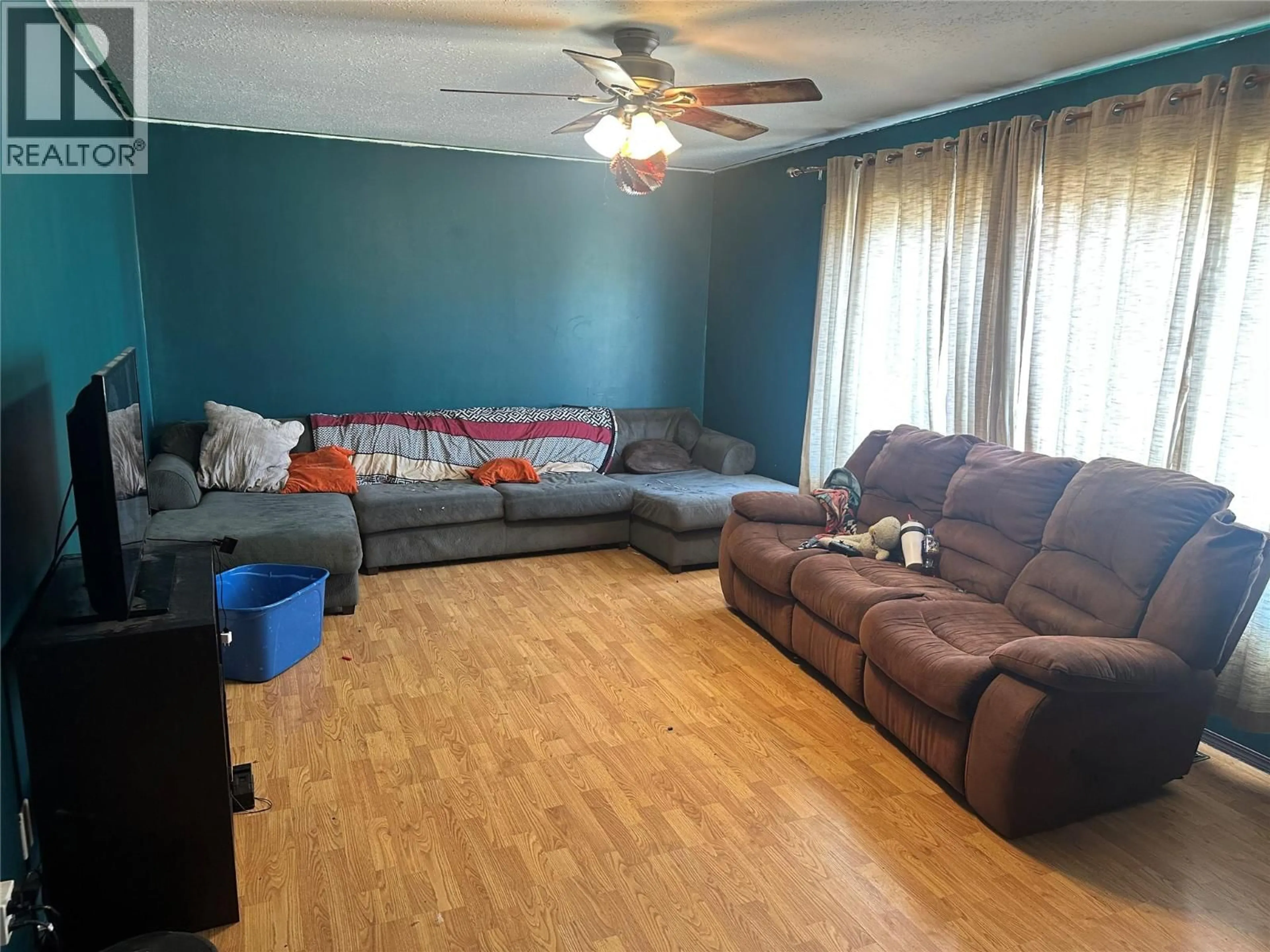 Living room with furniture, wood/laminate floor for 1232 105 AVENUE, Dawson Creek British Columbia V1G2L7