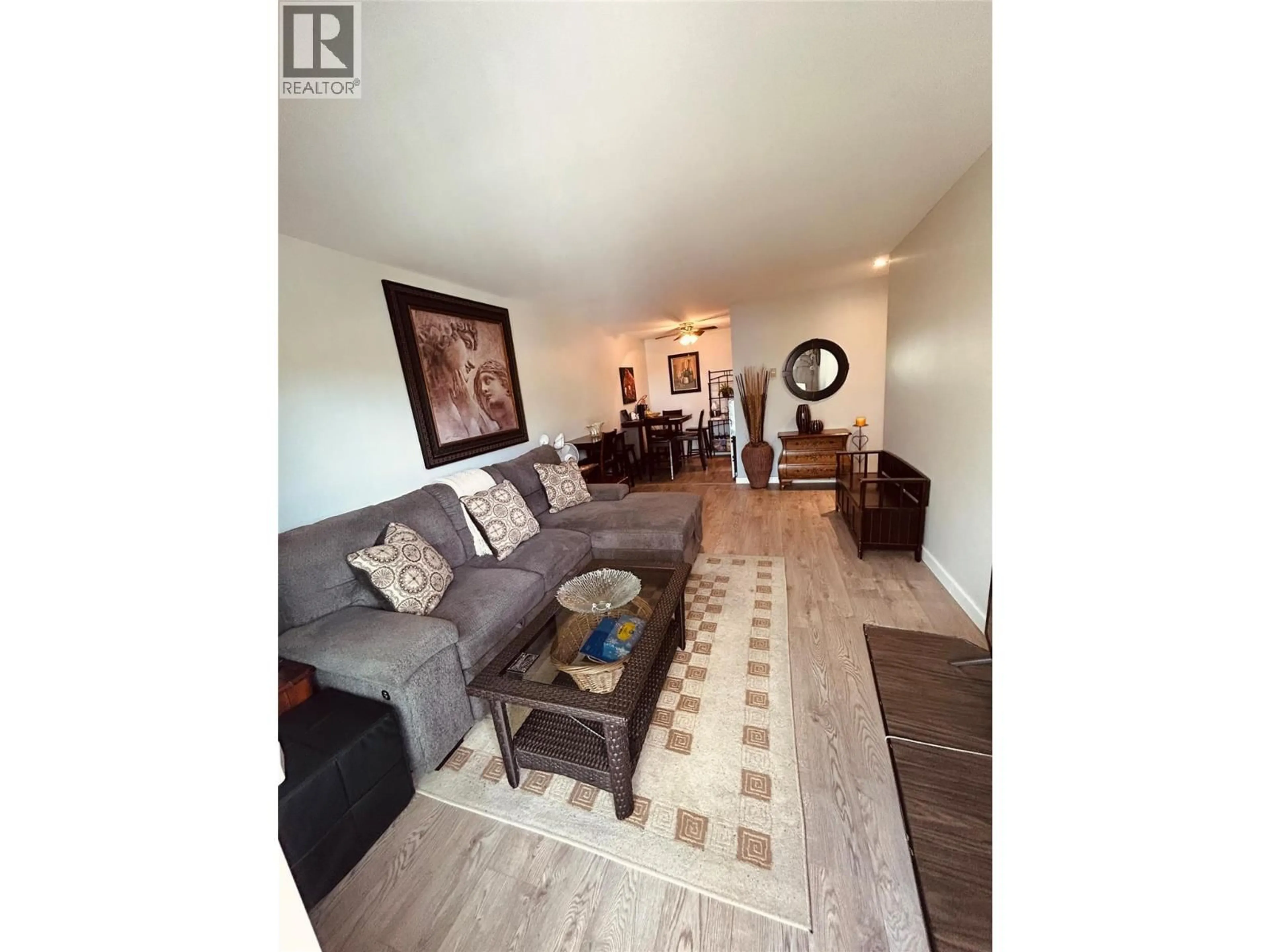 Living room with furniture, wood/laminate floor for 208 - 922 DYNES AVENUE, Penticton British Columbia V2A1E8