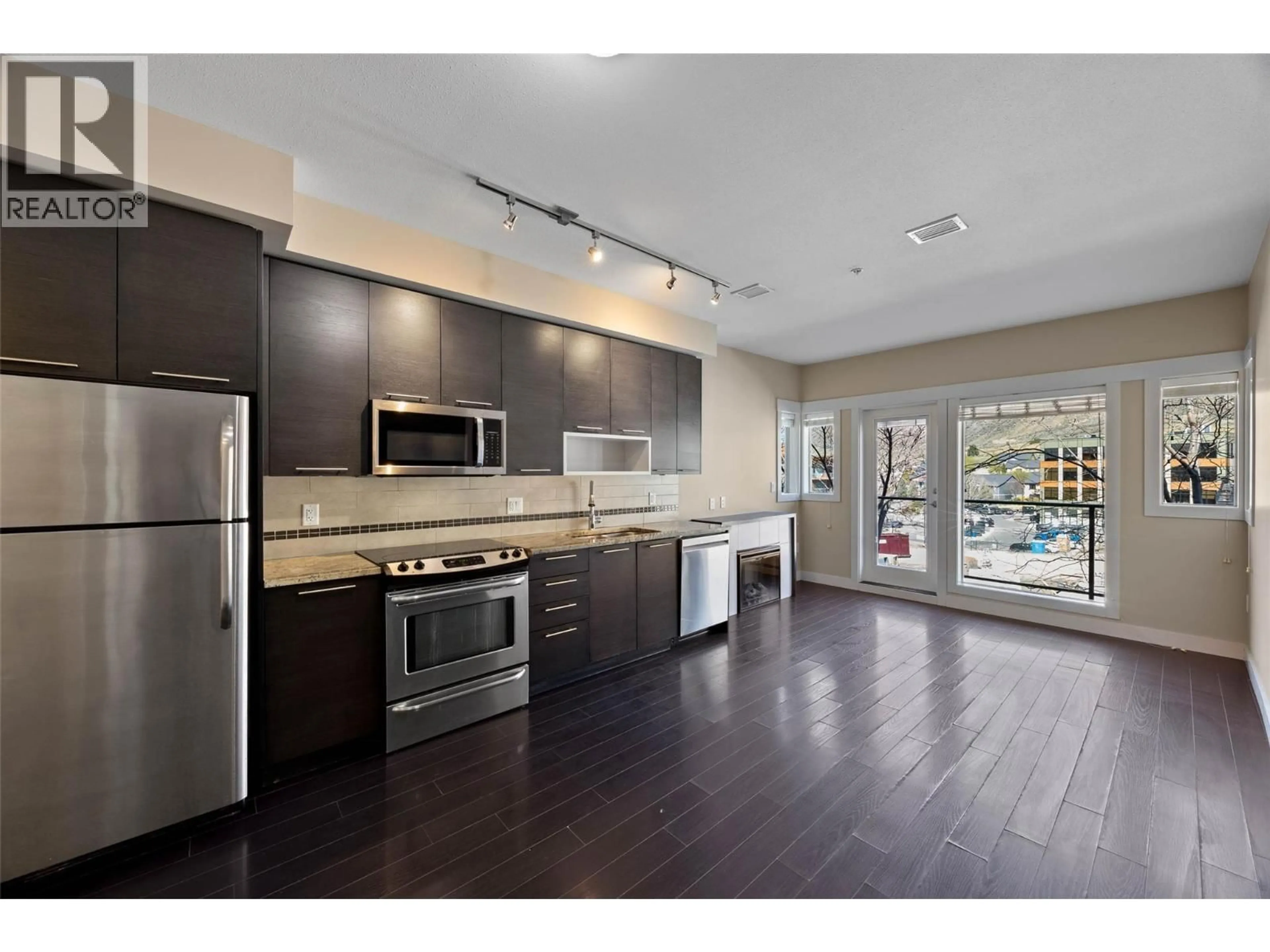 Open concept kitchen, wood/laminate floor for 2312 - 1030 TALASA WAY, Kamloops British Columbia V2H0C3