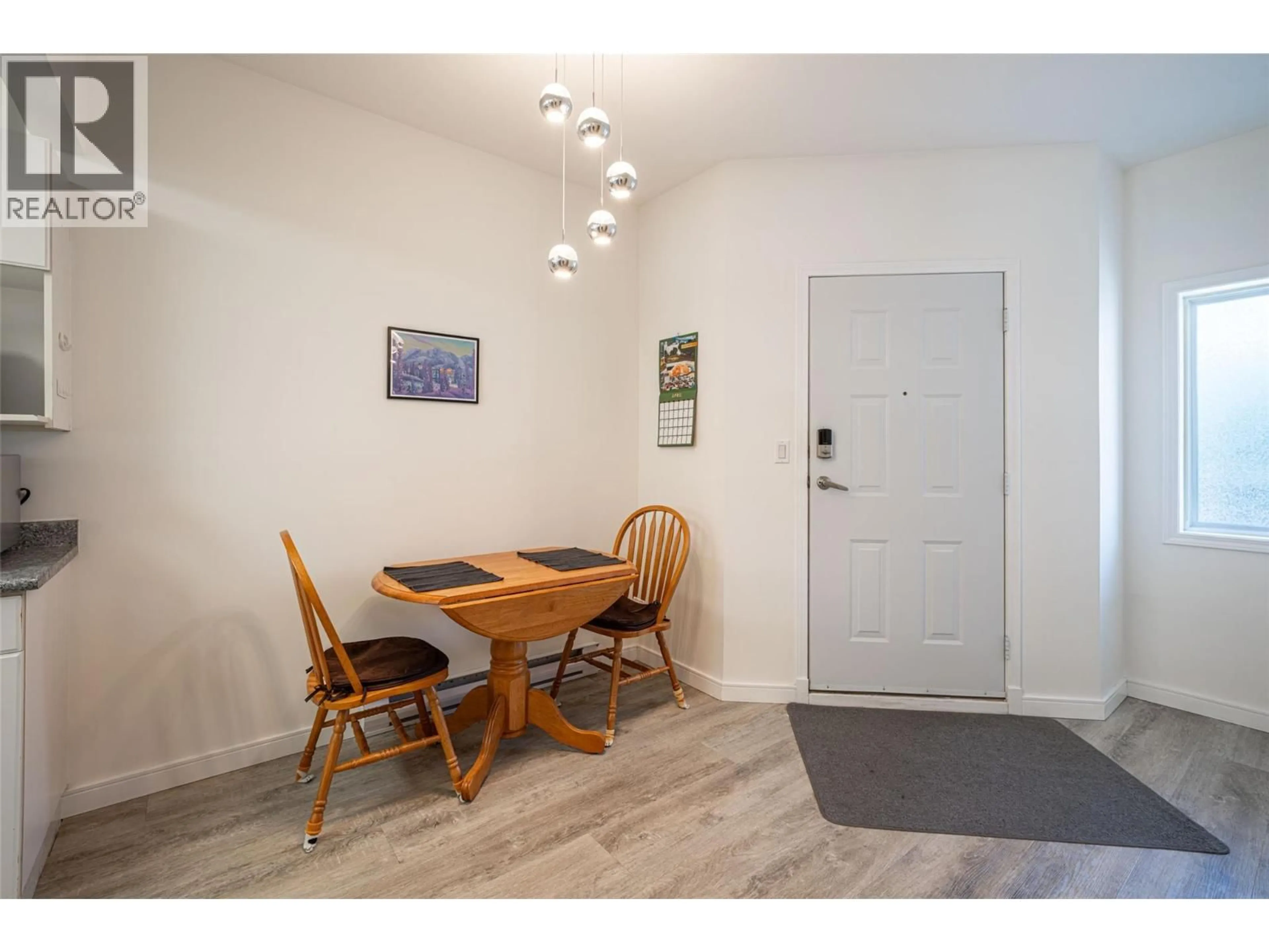 Dining room, wood/laminate floor for 10 - 4800 HERITAGE DRIVE, Vernon British Columbia V1T7V4