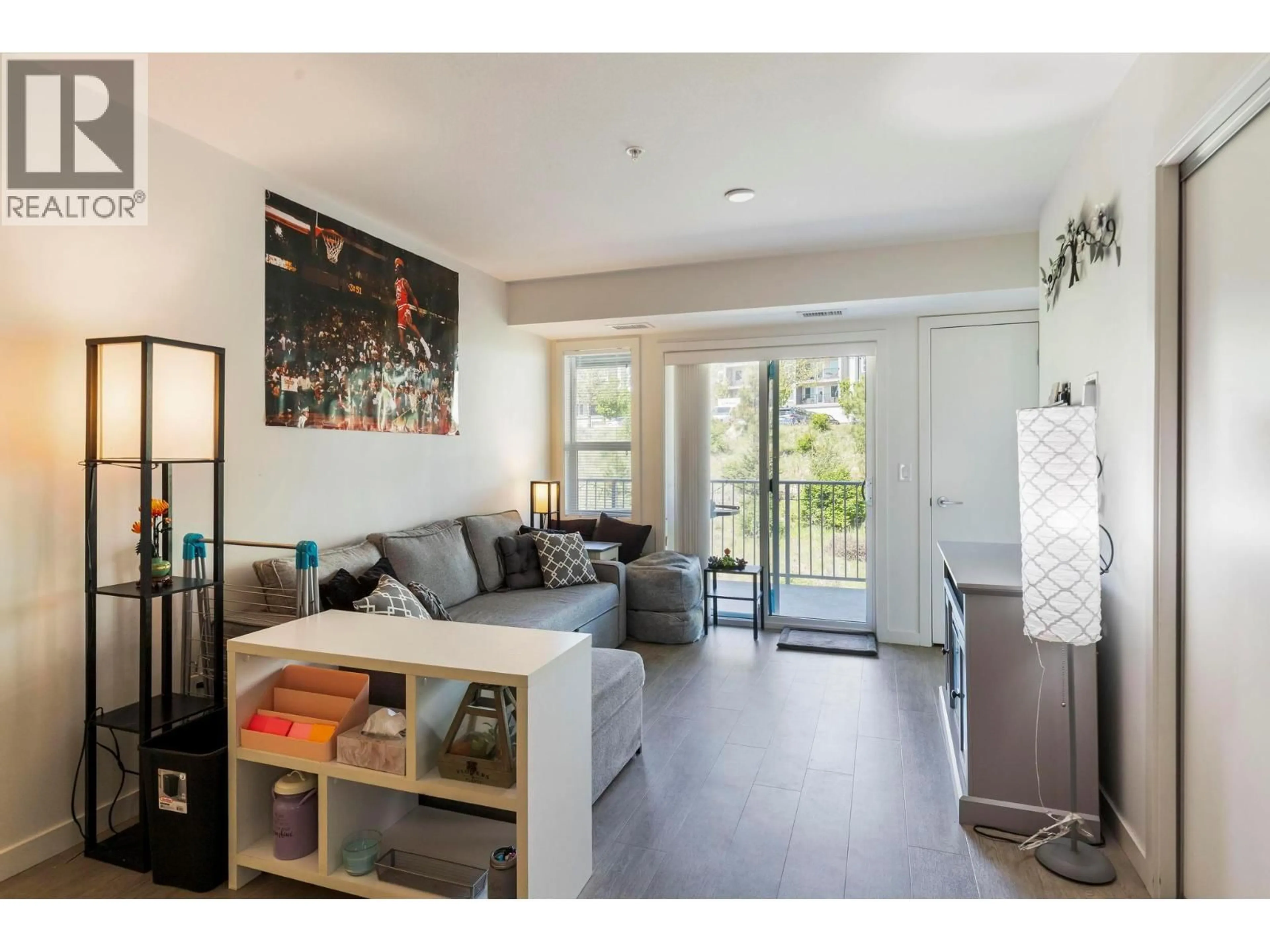 Living room with furniture, wood/laminate floor for 211 - 725 ACADEMY WAY, Kelowna British Columbia V1V0B4