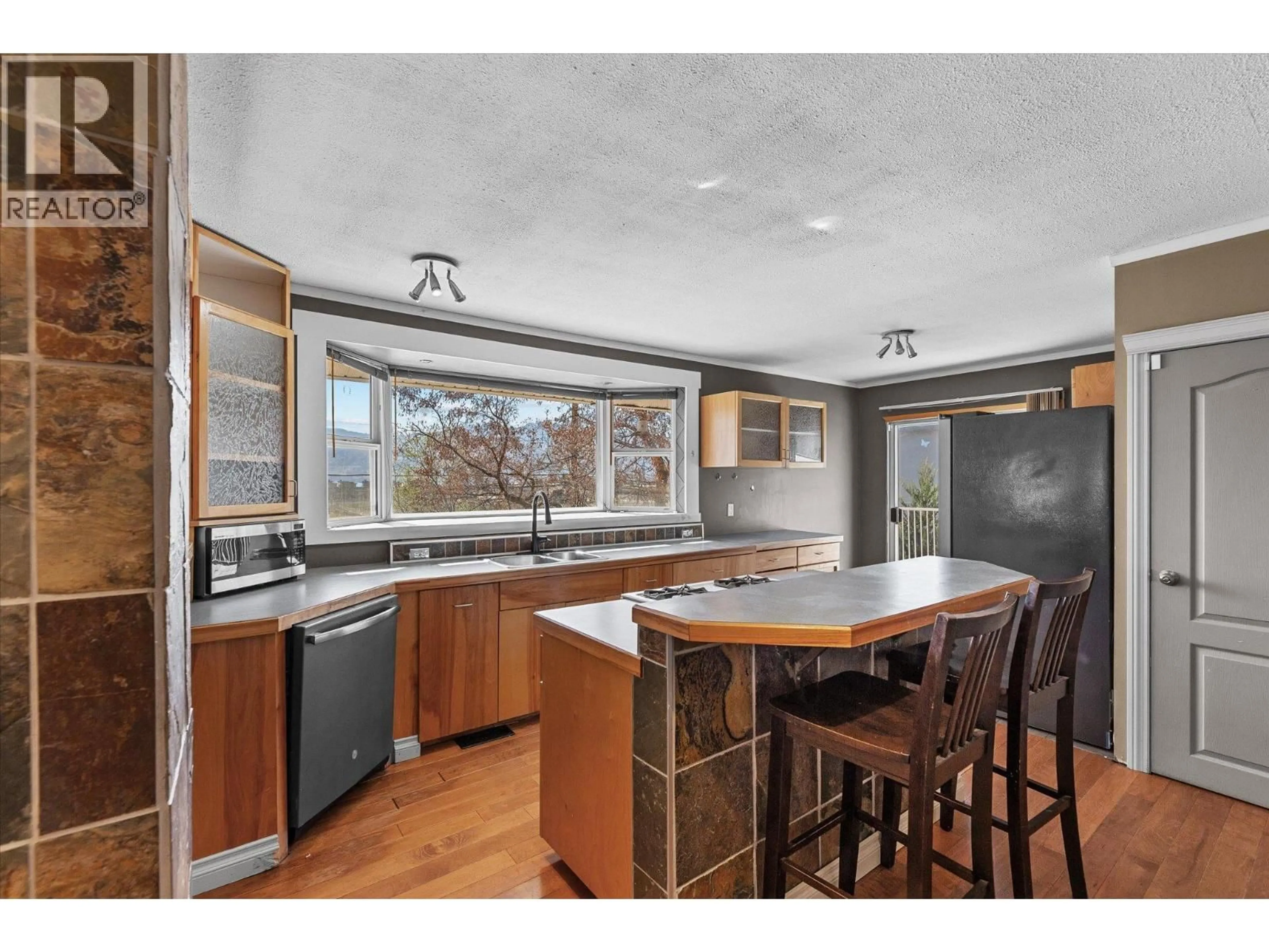 Open concept kitchen, wood/laminate floor for 3629 EMPIRE PLACE, West Kelowna British Columbia V4T1Y5