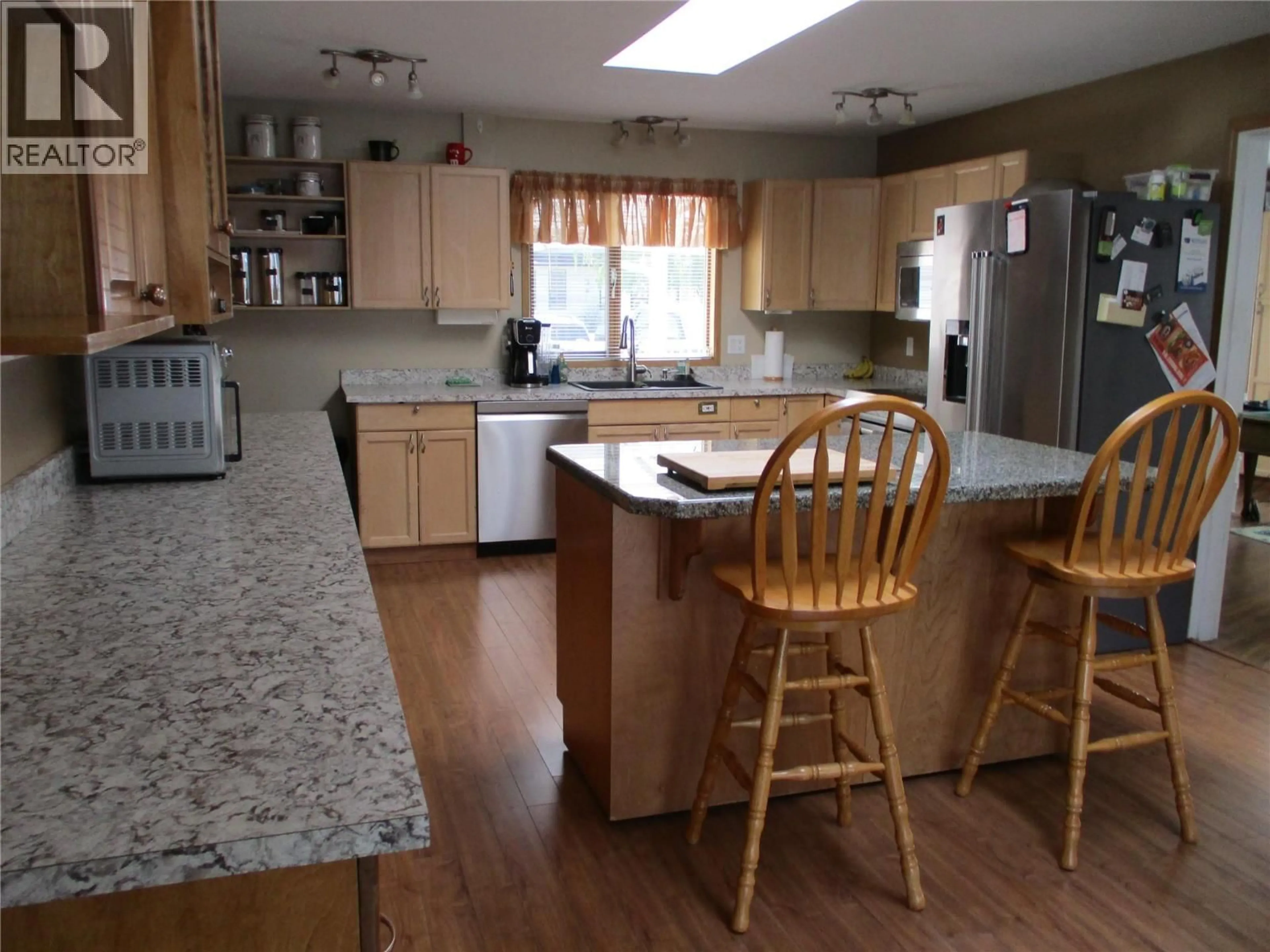 Open concept kitchen, wood/laminate floor for 106 CRESCENT DRIVE, Enderby British Columbia V4Y4A5