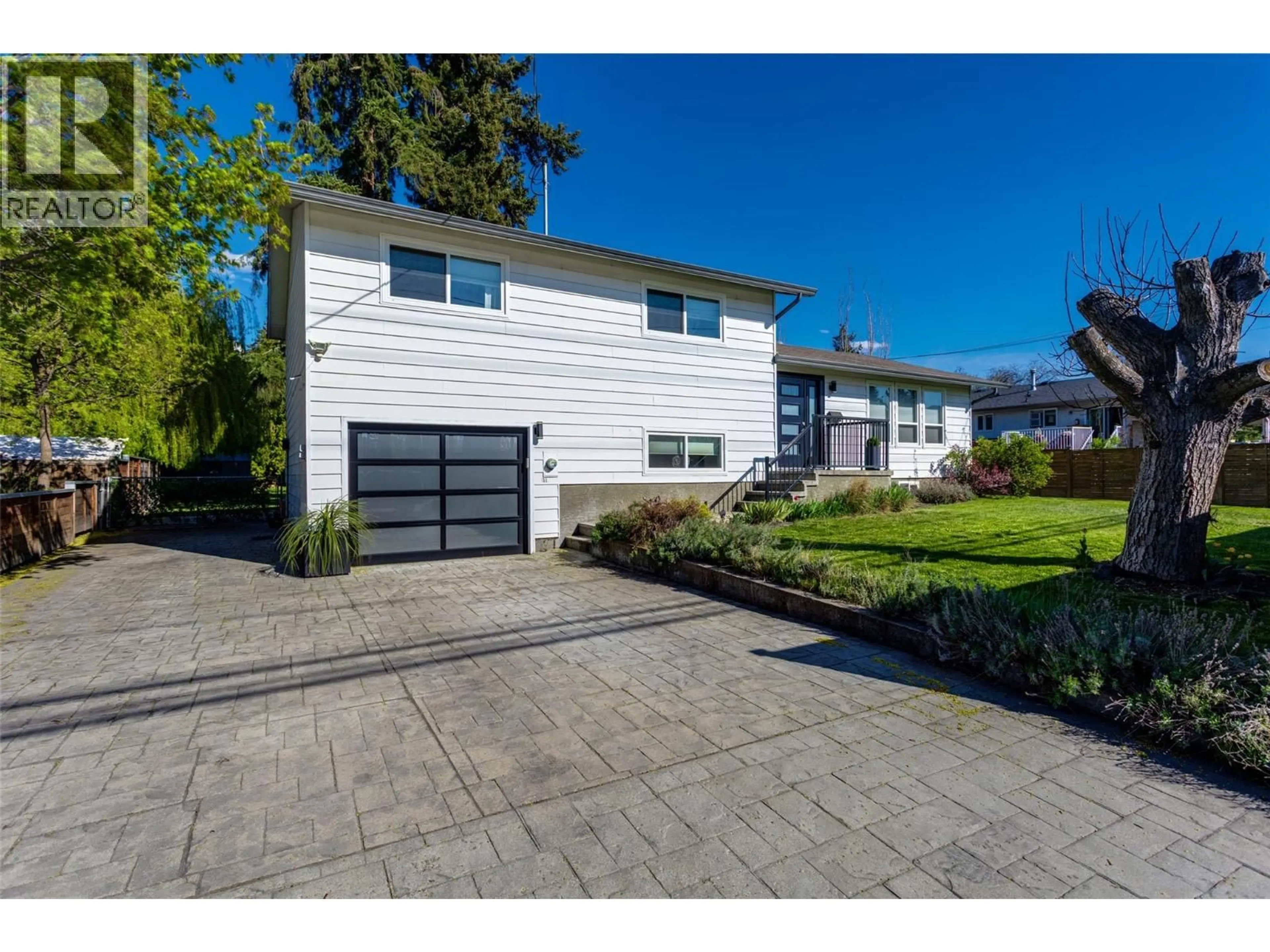 Home with vinyl exterior material, street for 4445 GORDON DRIVE, Kelowna British Columbia V1W1S9