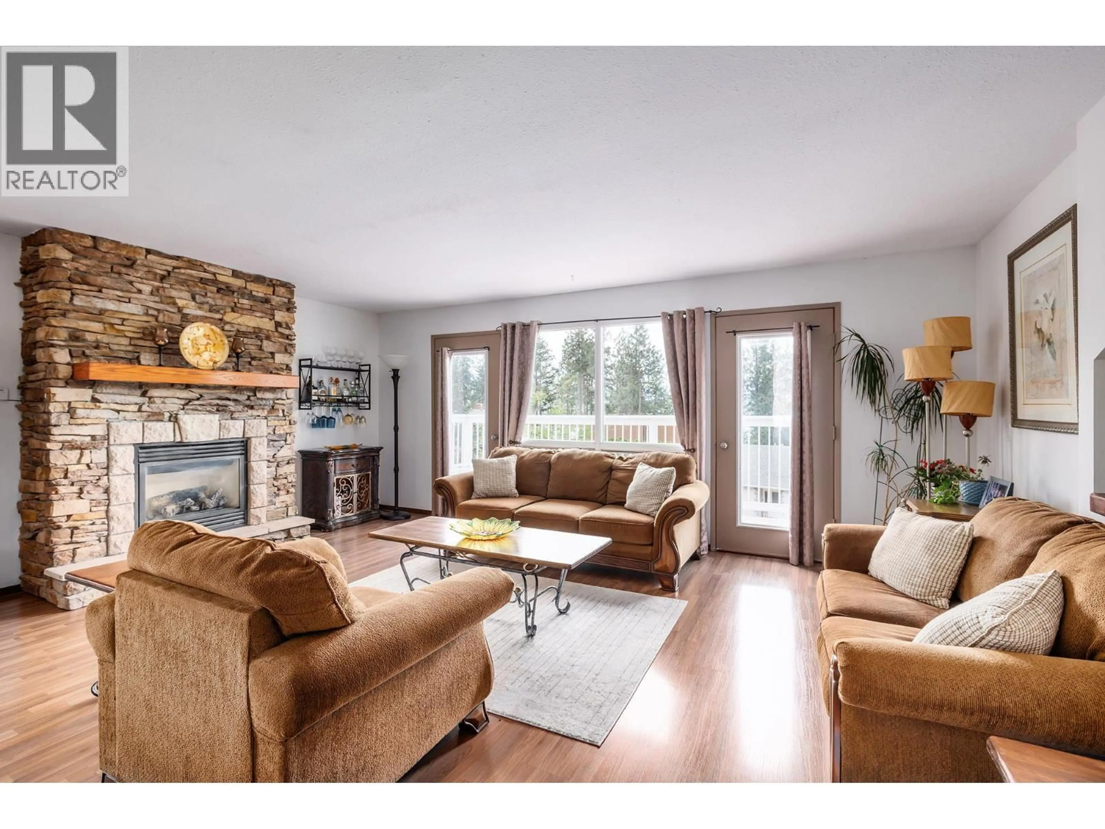 Living room with furniture, wood/laminate floor for 3944 TREPANIER HEIGHTS AVENUE, Peachland British Columbia V0H1X2