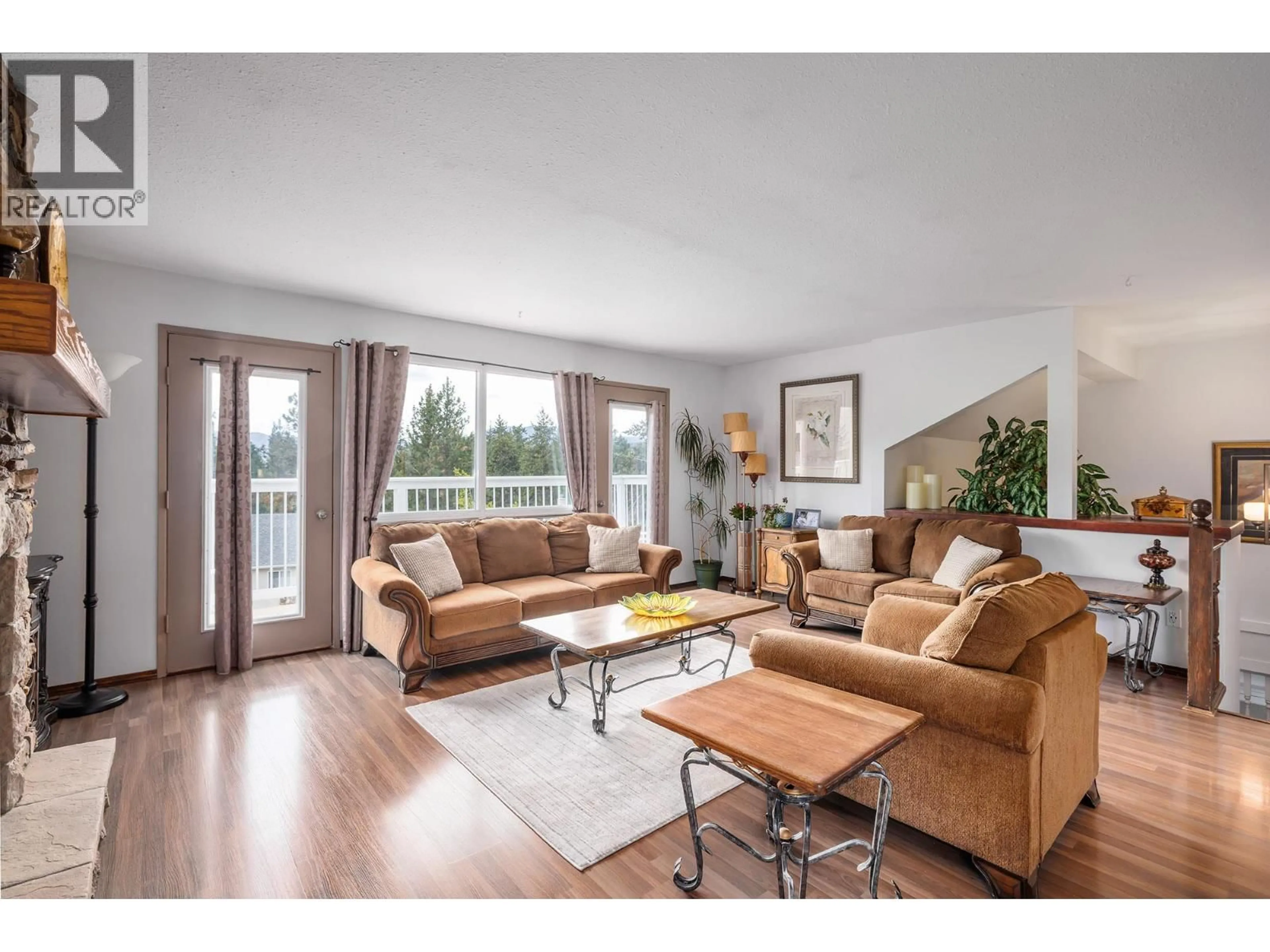 Living room with furniture, wood/laminate floor for 3944 TREPANIER HEIGHTS AVENUE, Peachland British Columbia V0H1X2