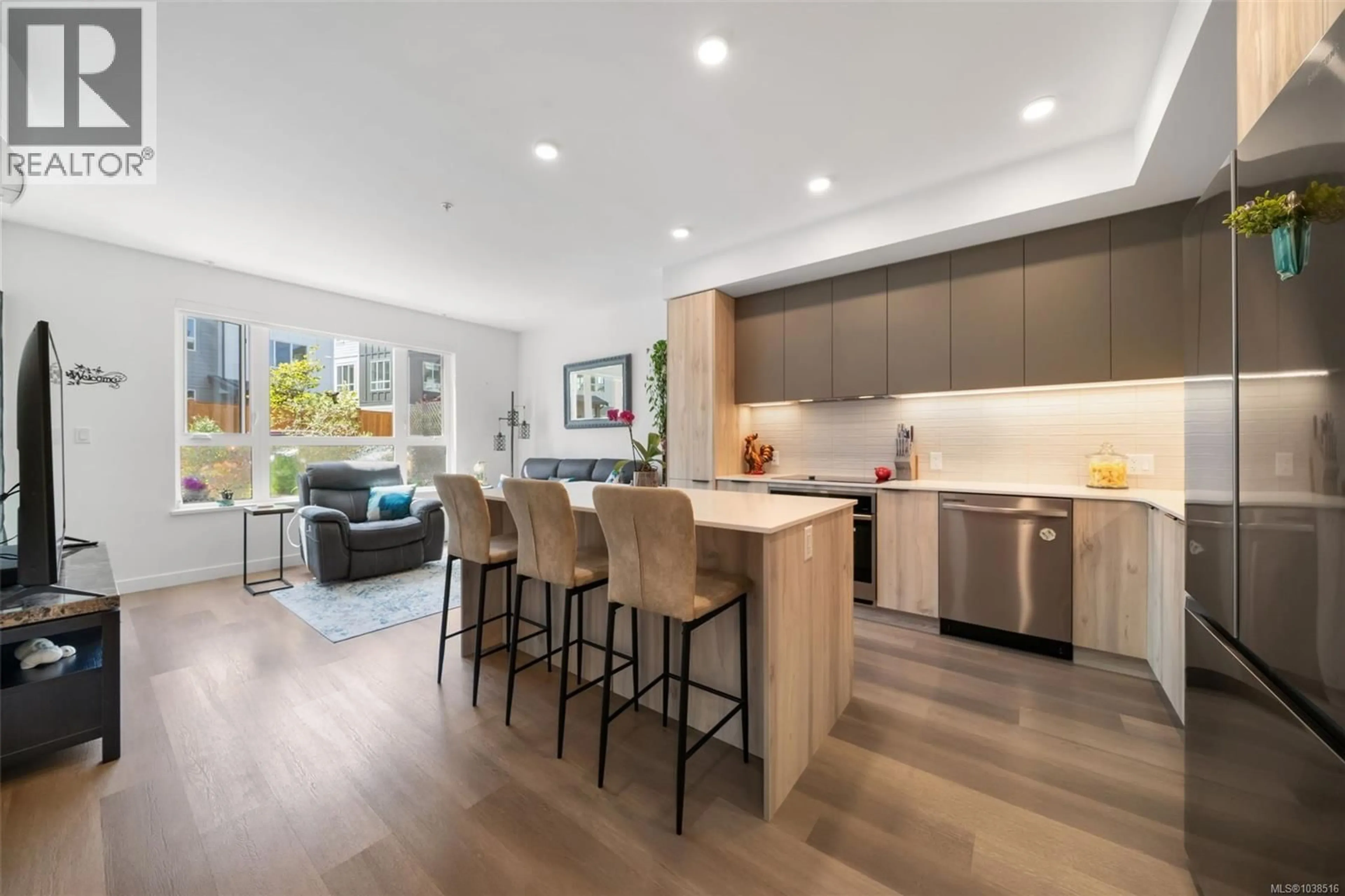 Open concept kitchen, wood/laminate floor for 102 - 3564 B RYDER HESJEDAL WAY, Colwood British Columbia V9C0V3