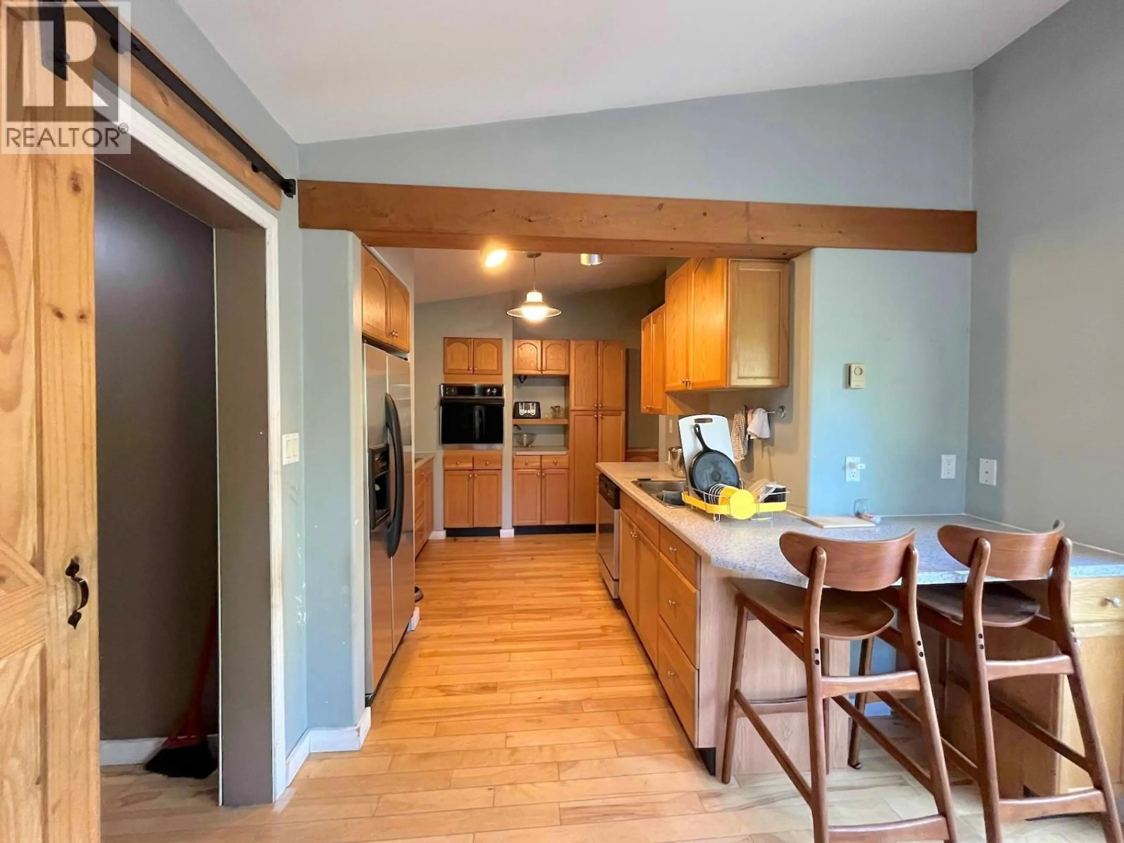 Open concept kitchen, wood/laminate floor for 102 CHASE ROAD, Christina Lake British Columbia V0H1E0