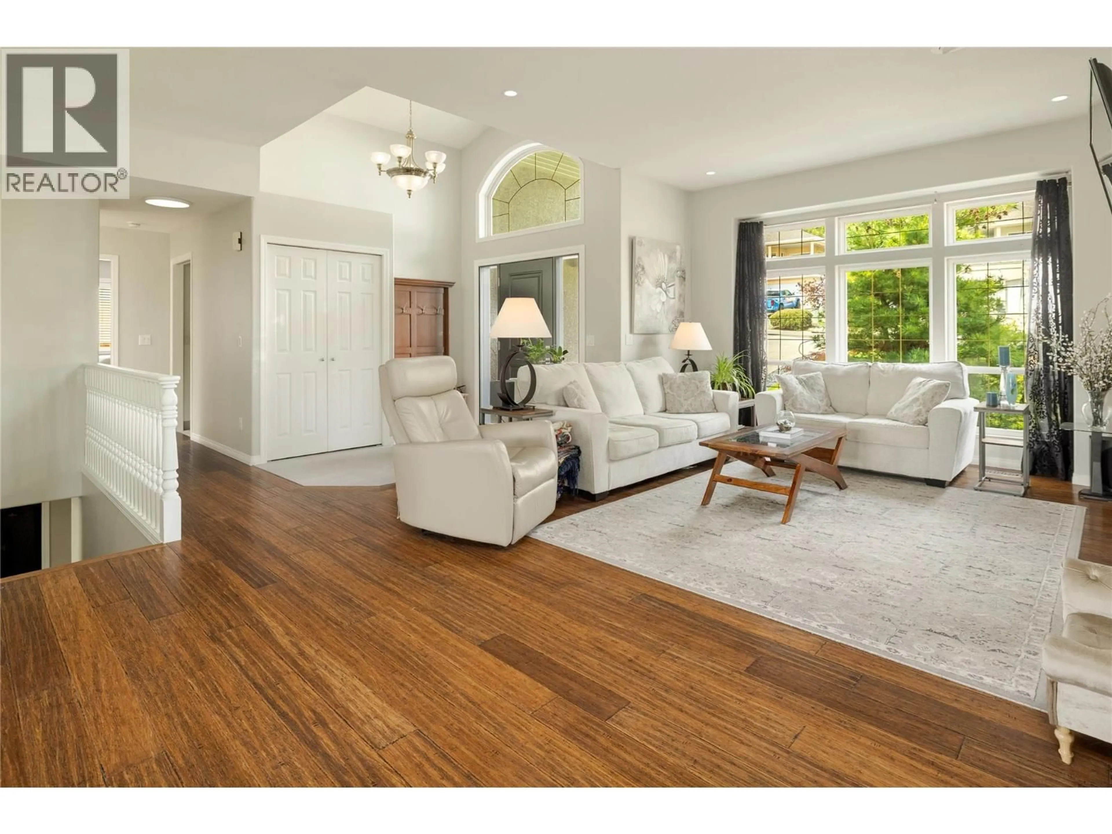 Living room with furniture, wood/laminate floor for 1061 CALEDONIA WAY, West Kelowna British Columbia V1Z3N7