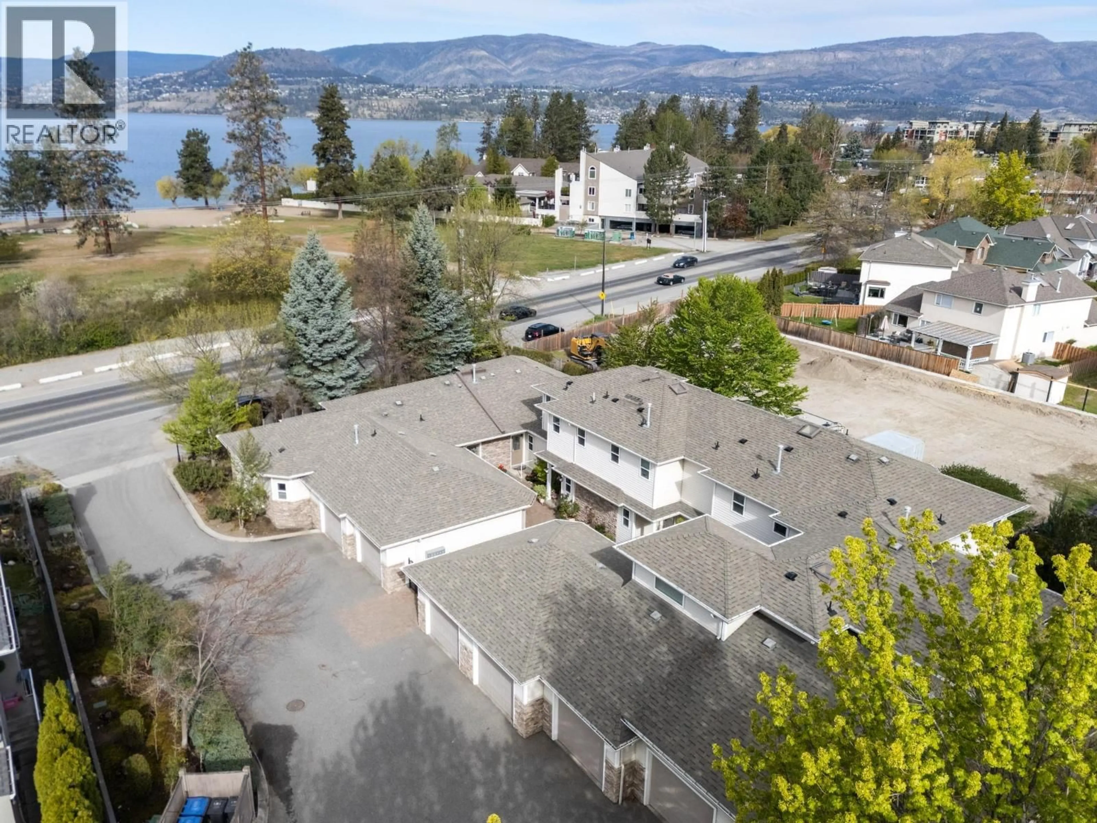 A pic from outside/outdoor area/front of a property/back of a property/a pic from drone, water/lake/river/ocean view for 103 - 4049 LAKESHORE ROAD, Kelowna British Columbia V1W1V7