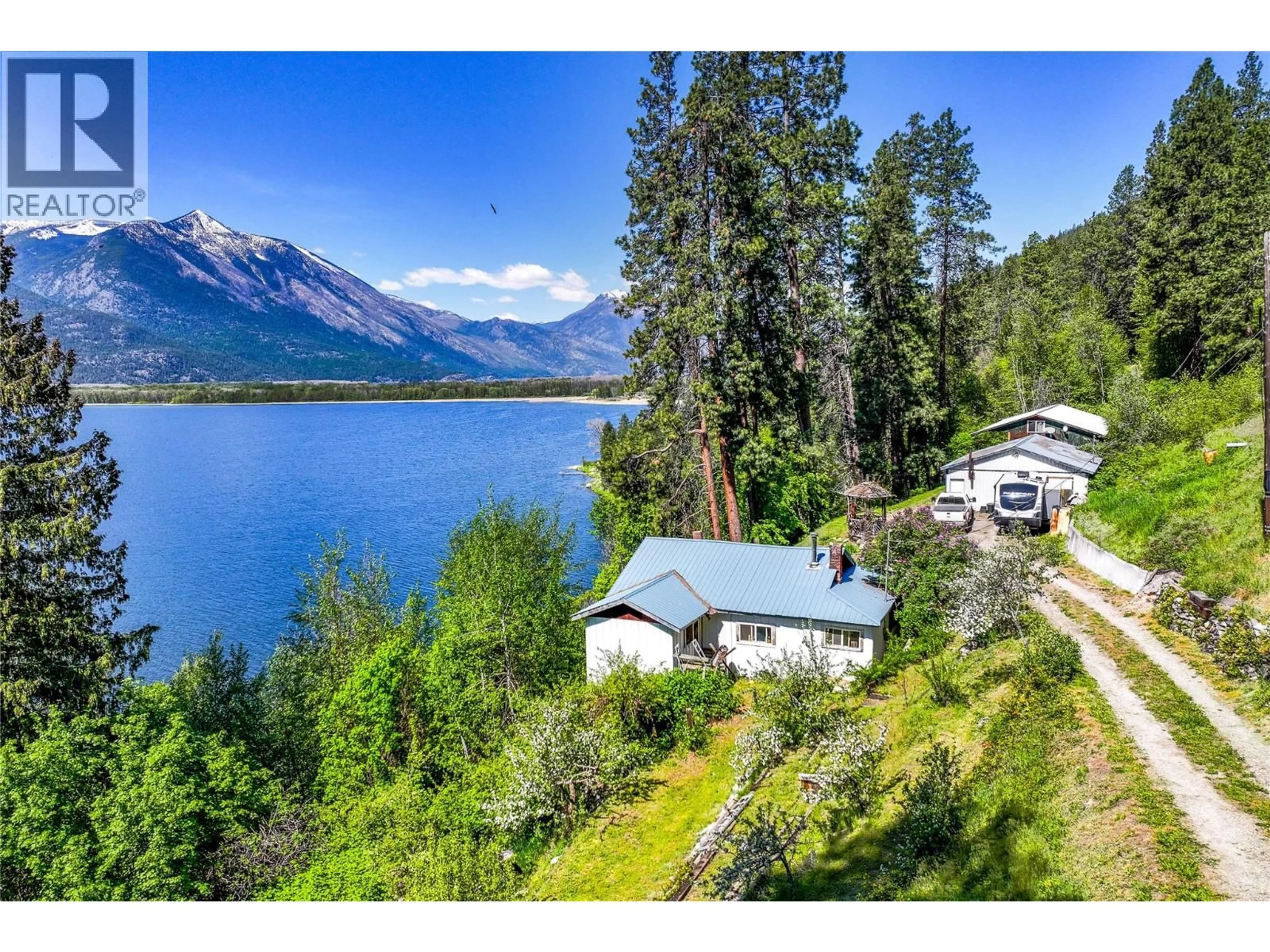 A pic from outside/outdoor area/front of a property/back of a property/a pic from drone, water/lake/river/ocean view for 8281 HWY 3A OTHER, Sirdar British Columbia V0B2C0