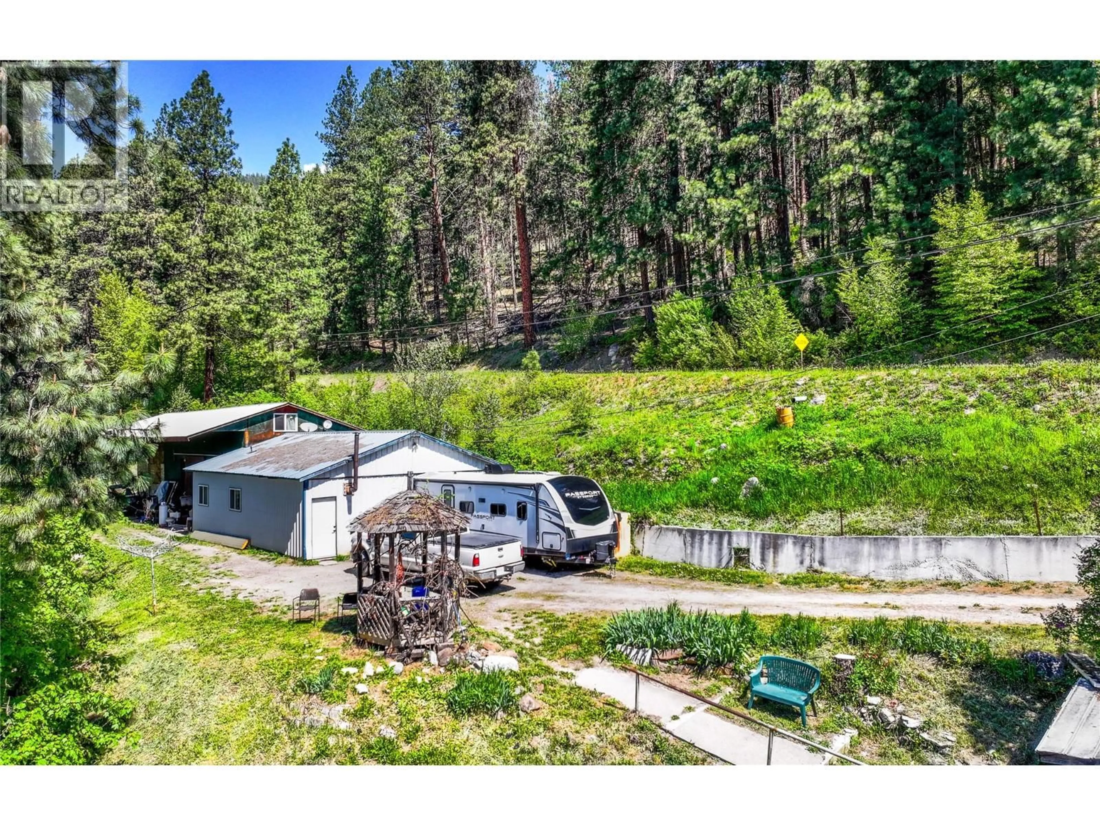 A pic from outside/outdoor area/front of a property/back of a property/a pic from drone, unknown for 8281 HWY 3A OTHER, Sirdar British Columbia V0B2C0