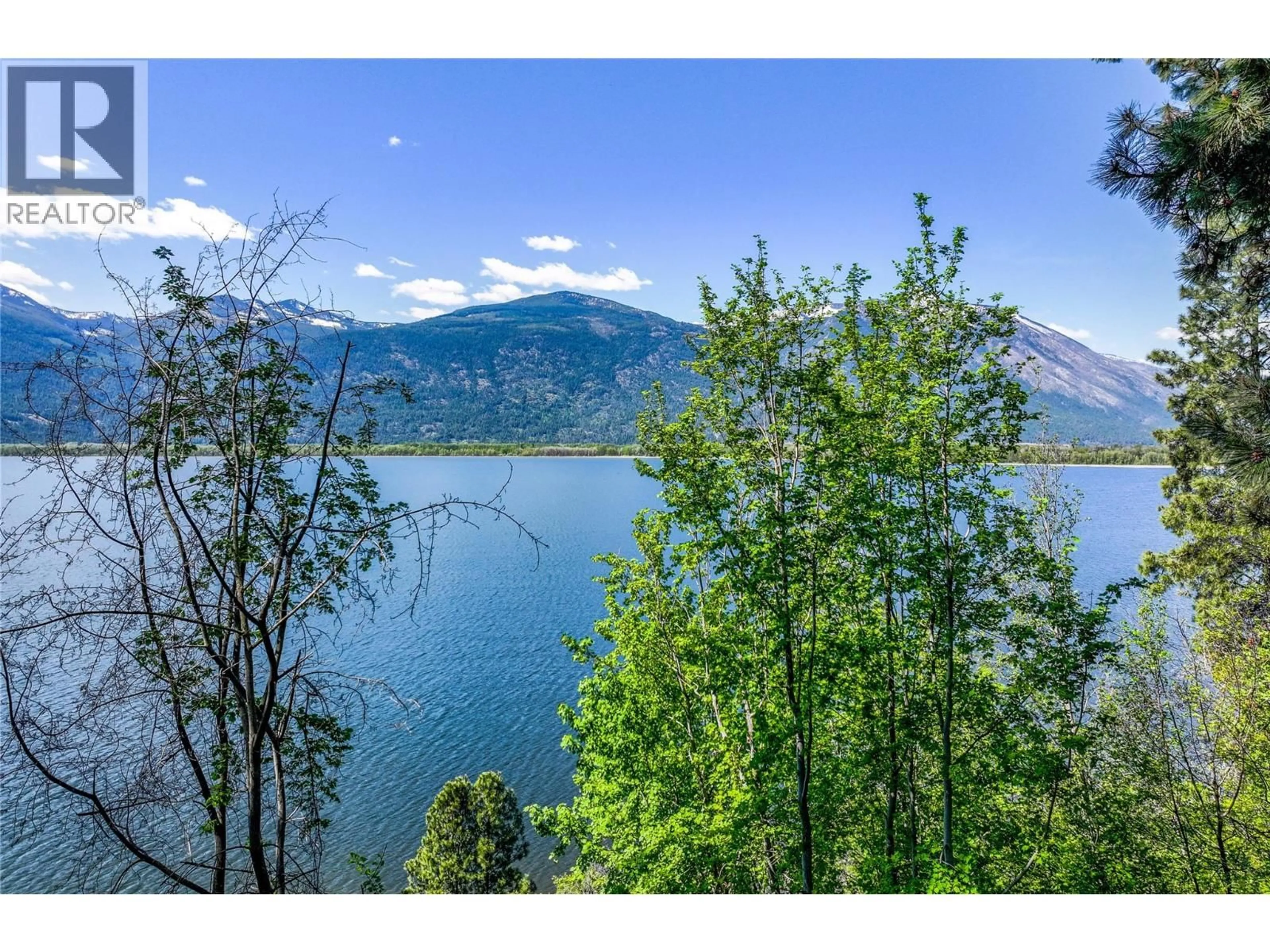 A pic from outside/outdoor area/front of a property/back of a property/a pic from drone, water/lake/river/ocean view for 8281 HWY 3A OTHER, Sirdar British Columbia V0B2C0