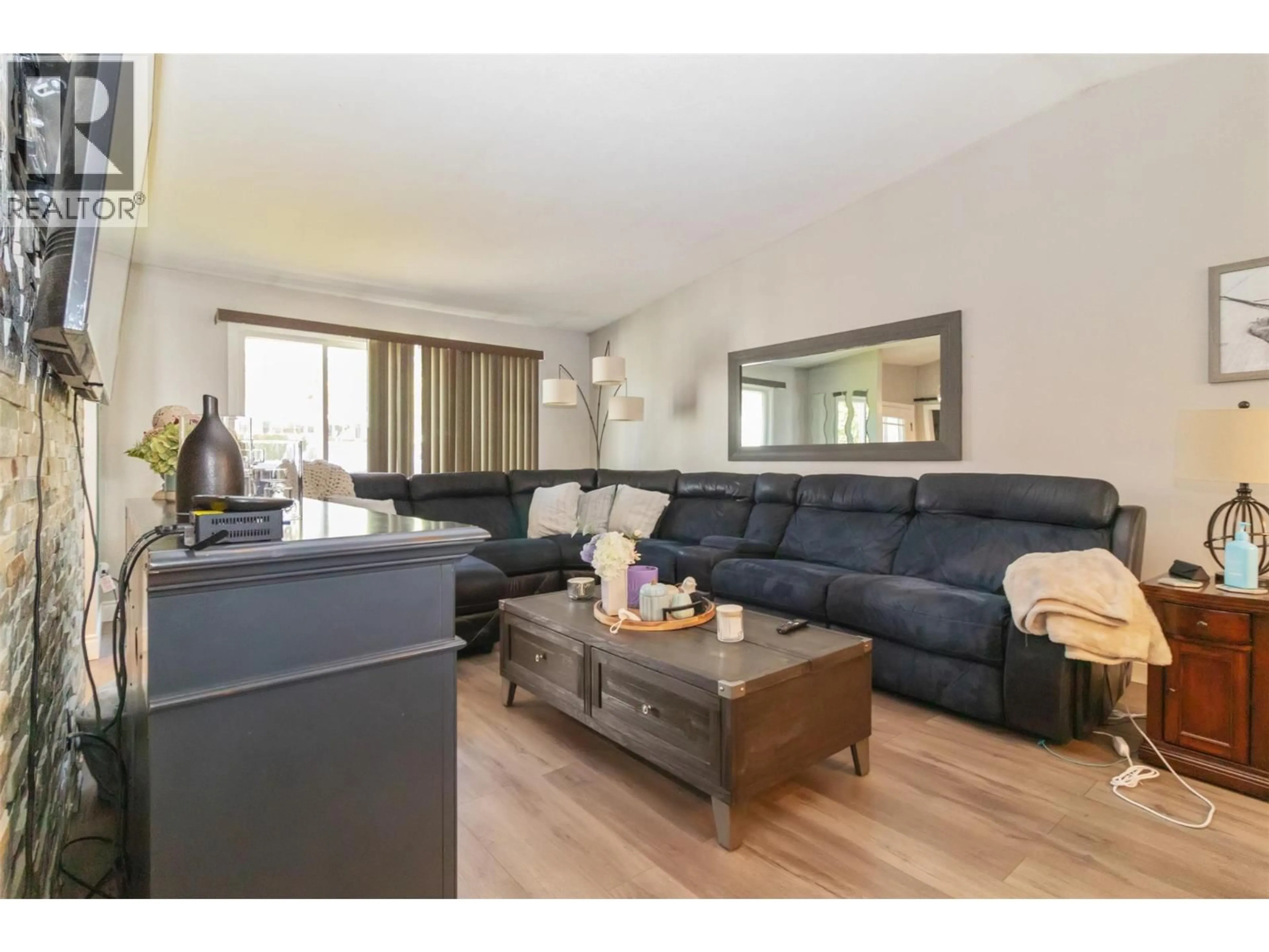 Living room with furniture, wood/laminate floor for 430 DOUGALL ROAD NORTH, Kelowna British Columbia V1X3K7