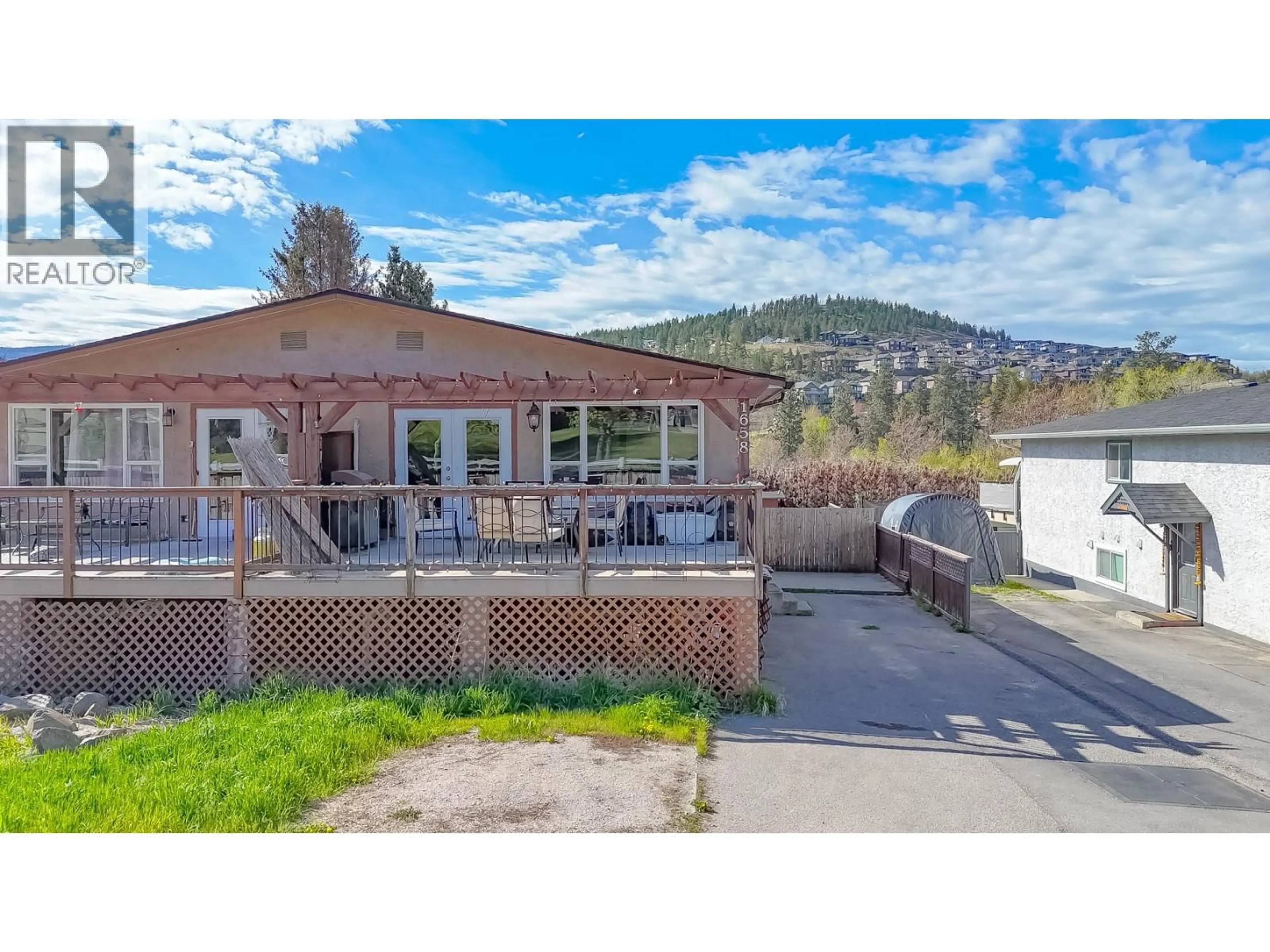 A pic from outside/outdoor area/front of a property/back of a property/a pic from drone, mountain view for 1658 LYNRICK ROAD, Kelowna British Columbia V1P1E8