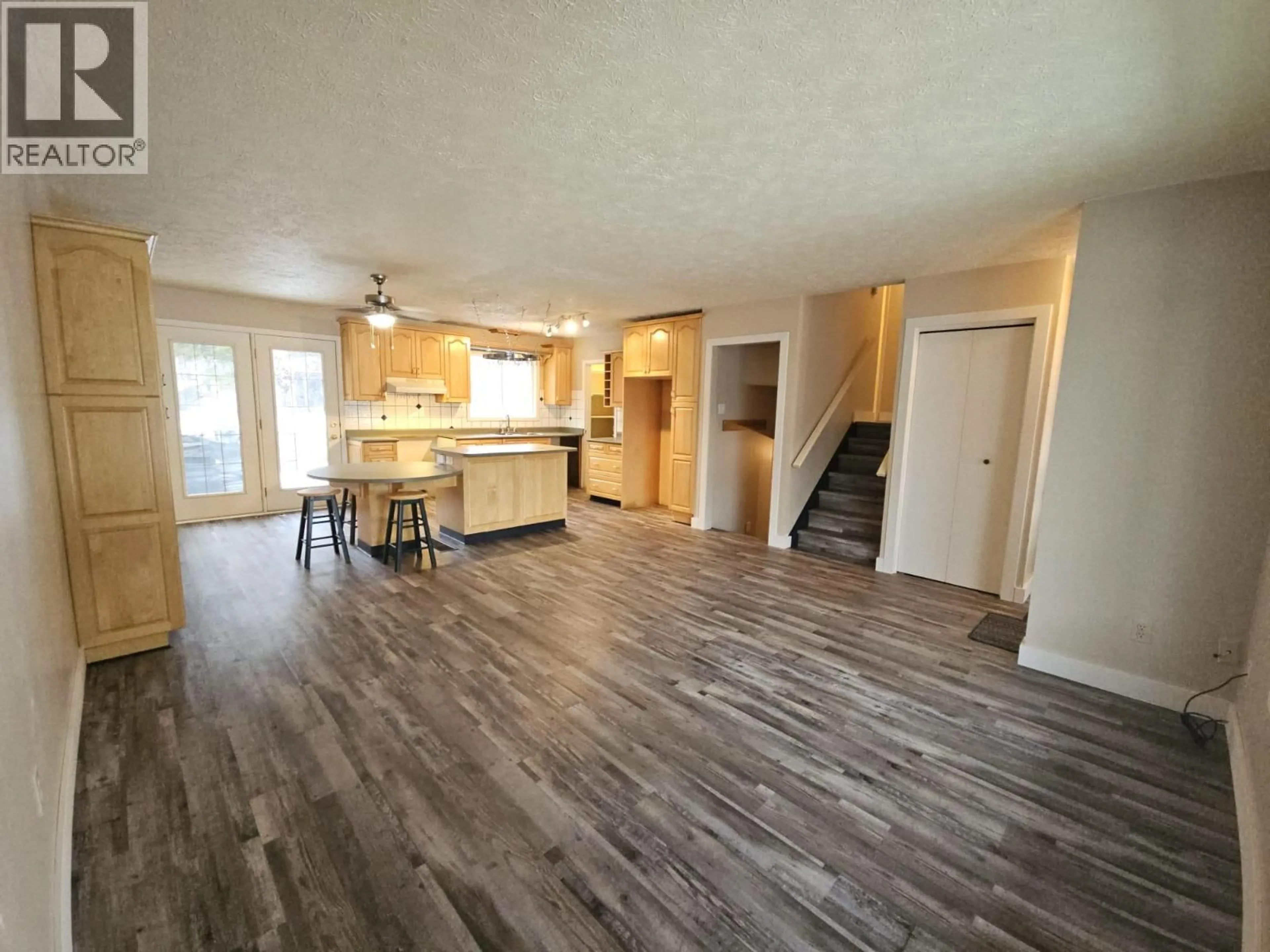 Open concept kitchen, wood/laminate floor for 143 KISKATINAW CRESCENT, Tumbler Ridge British Columbia V0C2W0