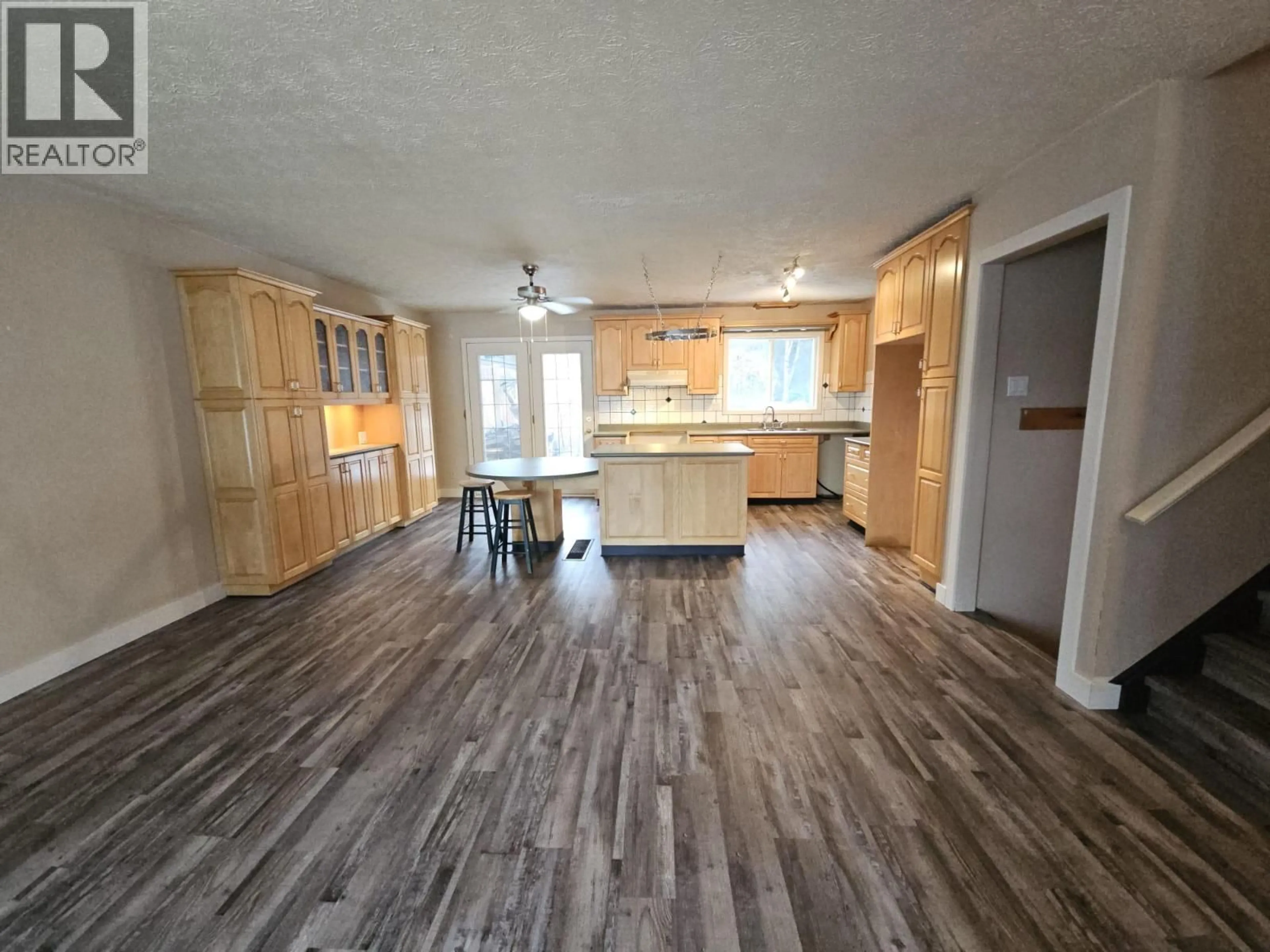 Open concept kitchen, wood/laminate floor for 143 KISKATINAW CRESCENT, Tumbler Ridge British Columbia V0C2W0
