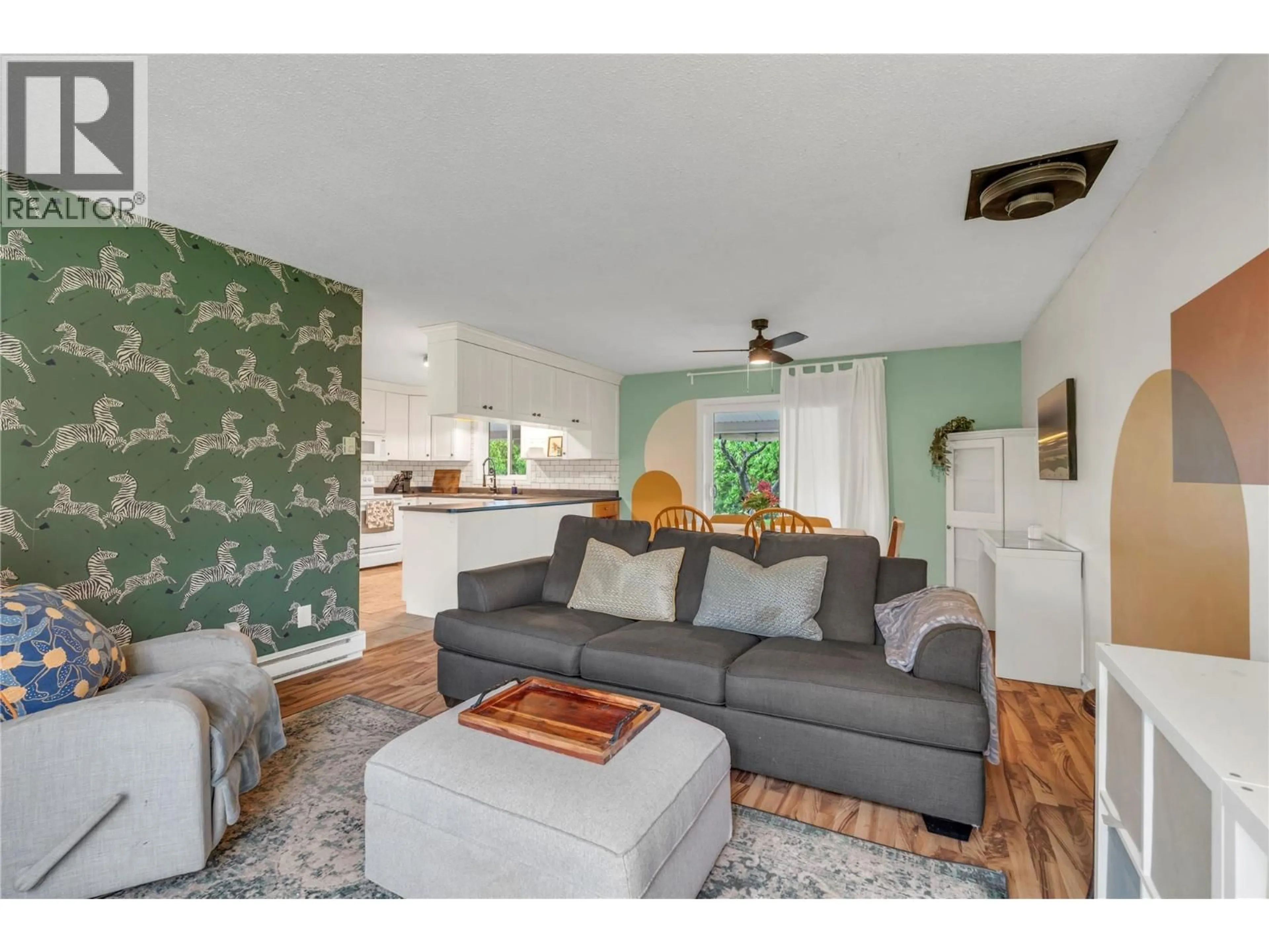 Living room with furniture, wood/laminate floor for 7513 CREST-A-WAY ROAD, Oliver British Columbia V0H1T0