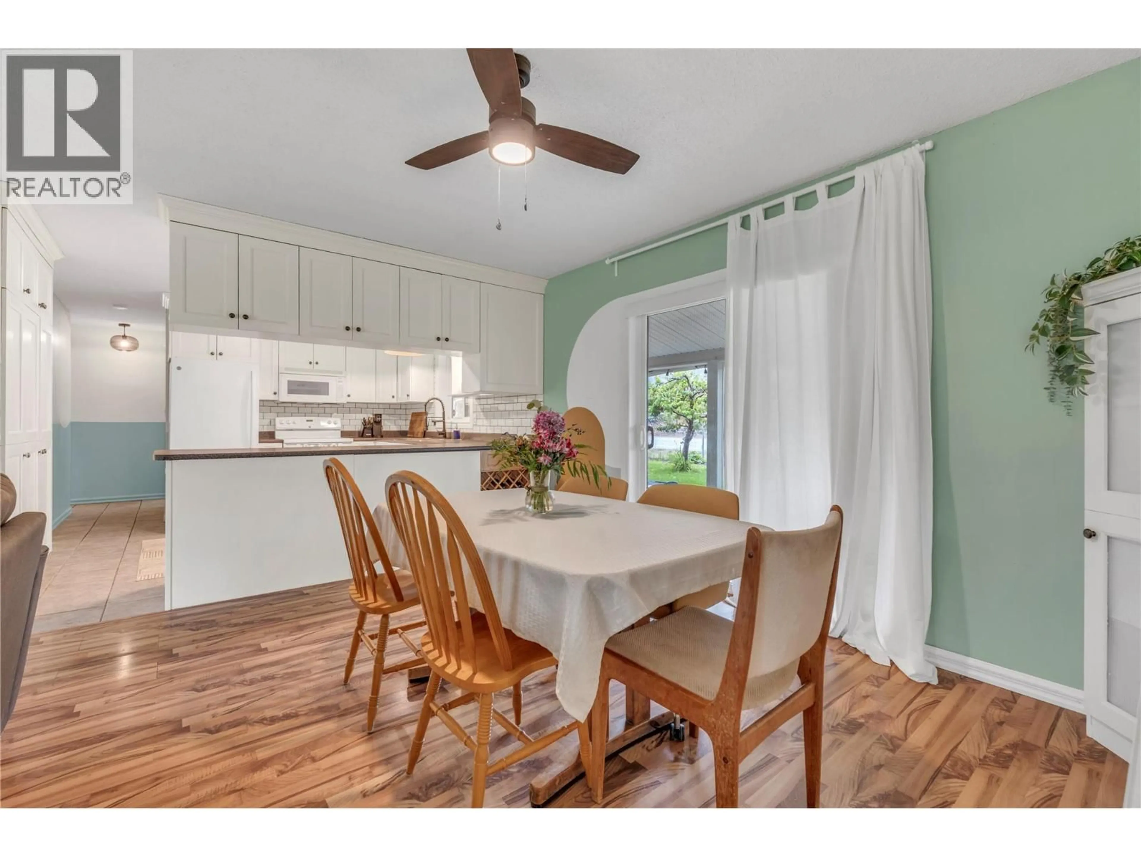 Open concept kitchen, wood/laminate floor for 7513 CREST-A-WAY ROAD, Oliver British Columbia V0H1T0