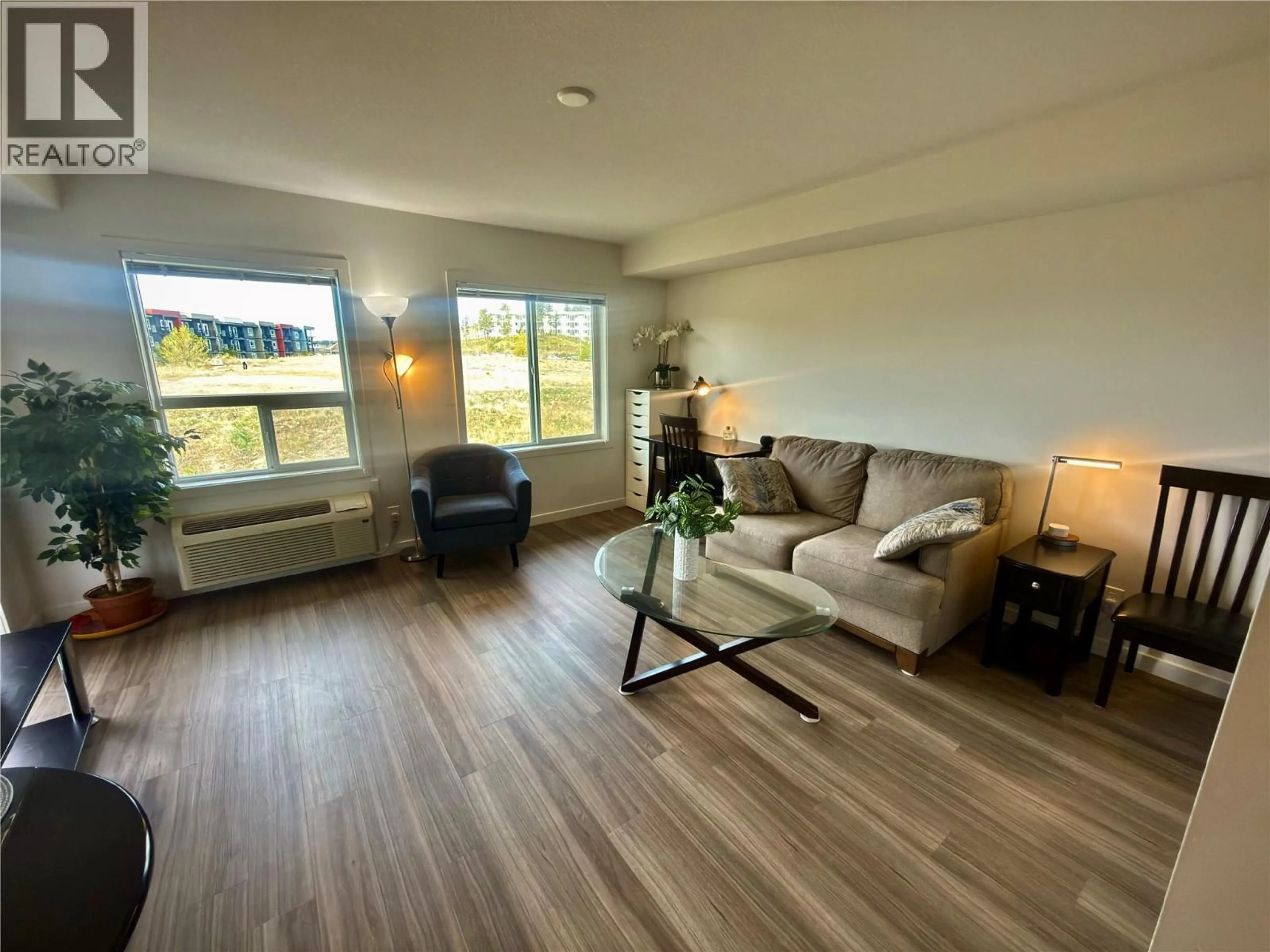 Living room with furniture, wood/laminate floor for PH7 - 883 ACADEMY WAY, Kelowna British Columbia V1V0A3
