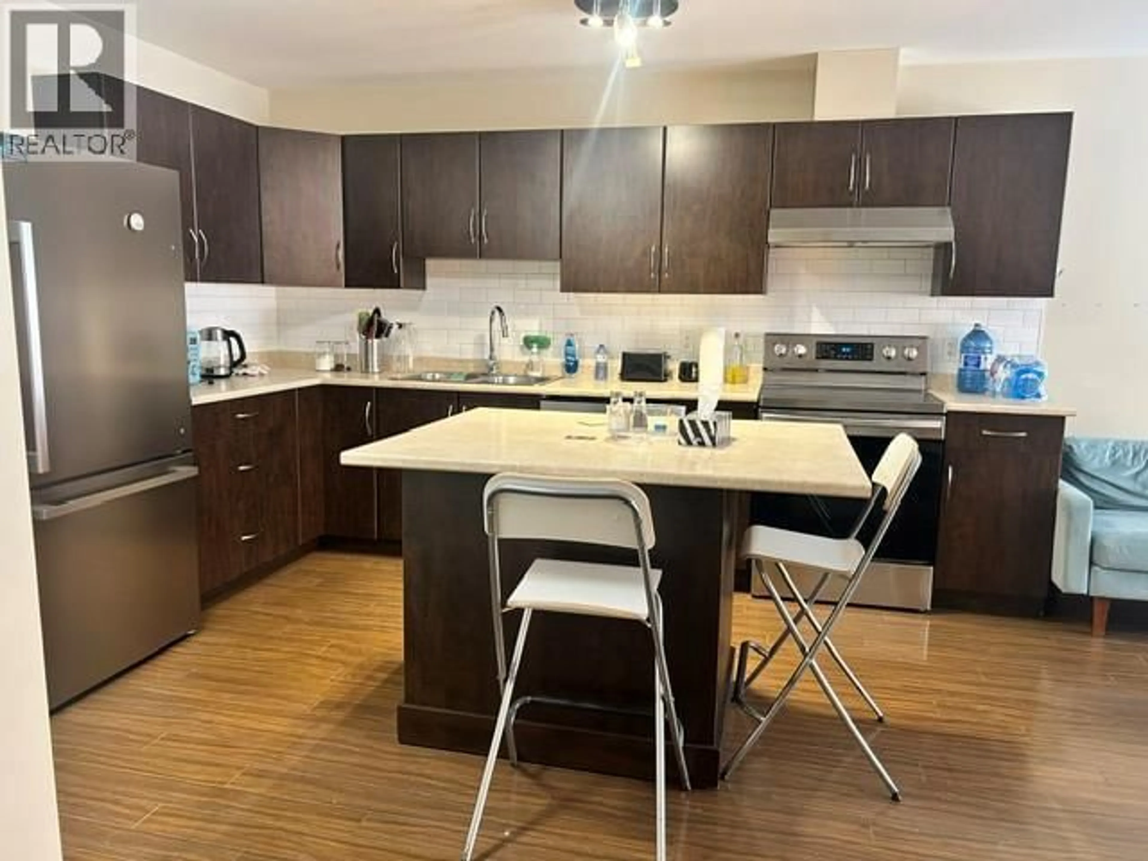 Open concept kitchen, wood/laminate floor for 308 - 1483 GLENMORE ROAD, Kelowna British Columbia V1V2C5