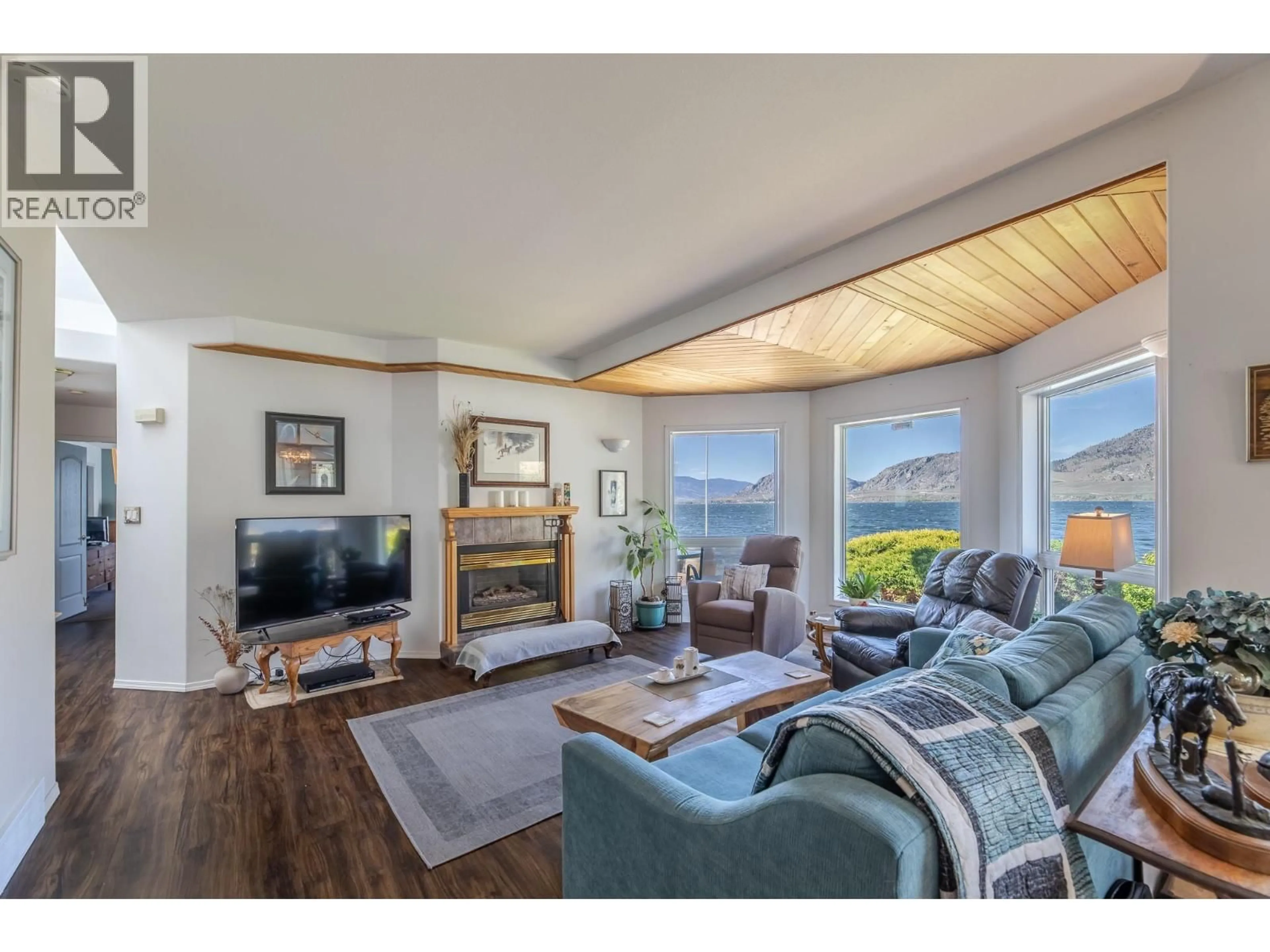 Living room with furniture, wood/laminate floor for 8405 104TH AVENUE, Osoyoos British Columbia V0H1V2