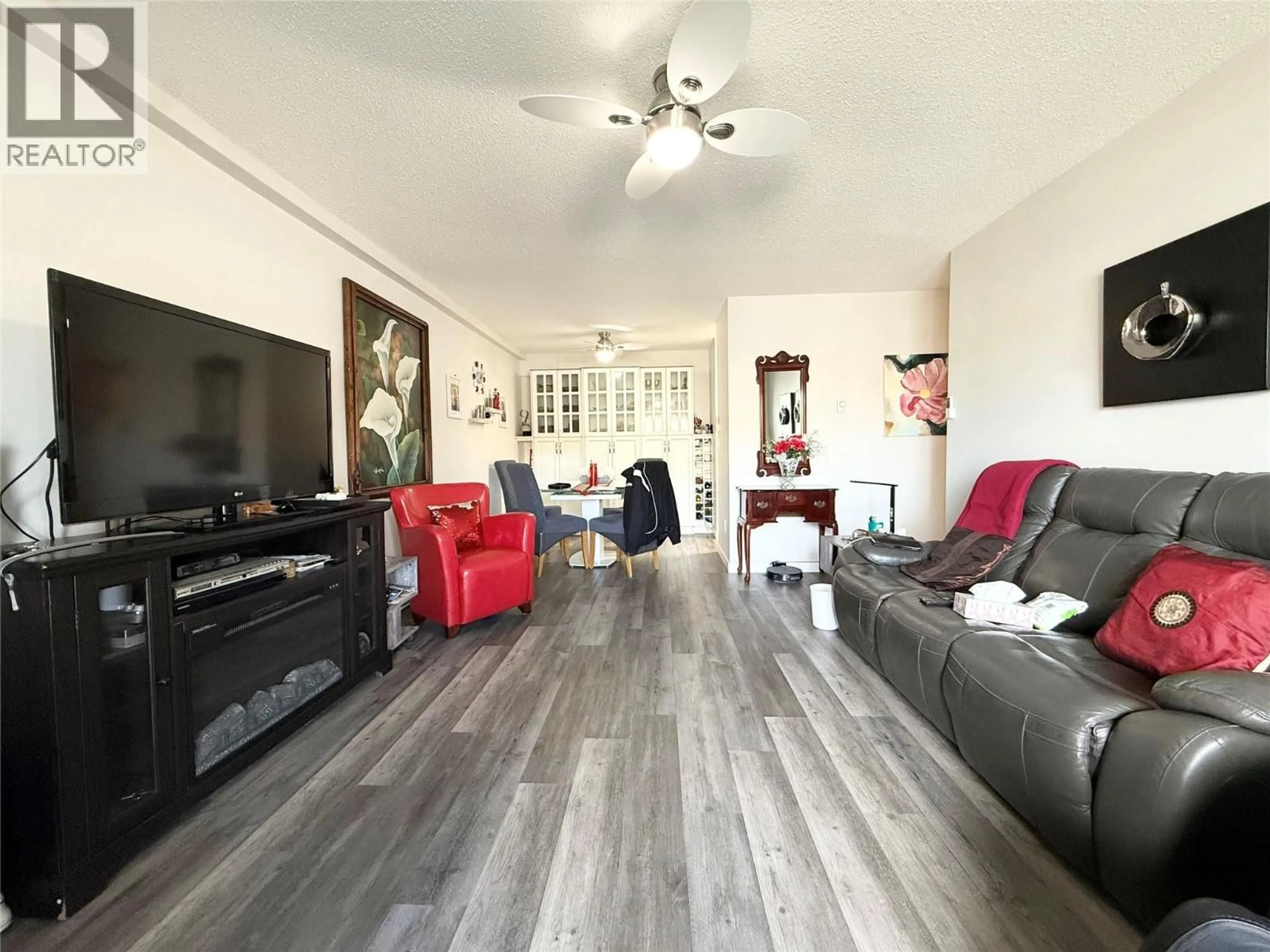 Living room with furniture, wood/laminate floor for 108 - 1703 MENZIES STREET, Merritt British Columbia V1K1A6