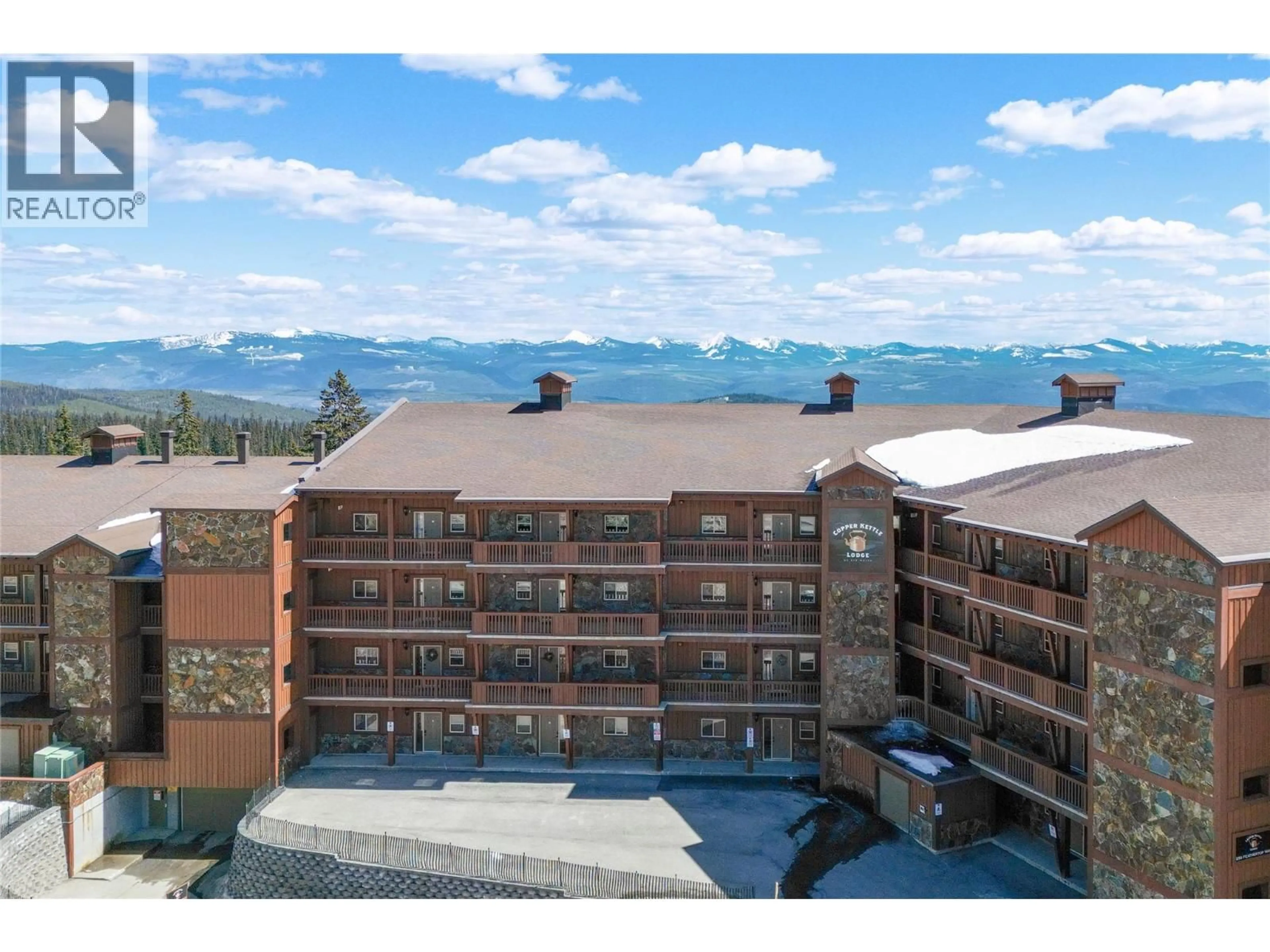 A pic from outside/outdoor area/front of a property/back of a property/a pic from drone, mountain view for 409 - 250 FEATHERTOP WAY, Kelowna British Columbia V1P1P3