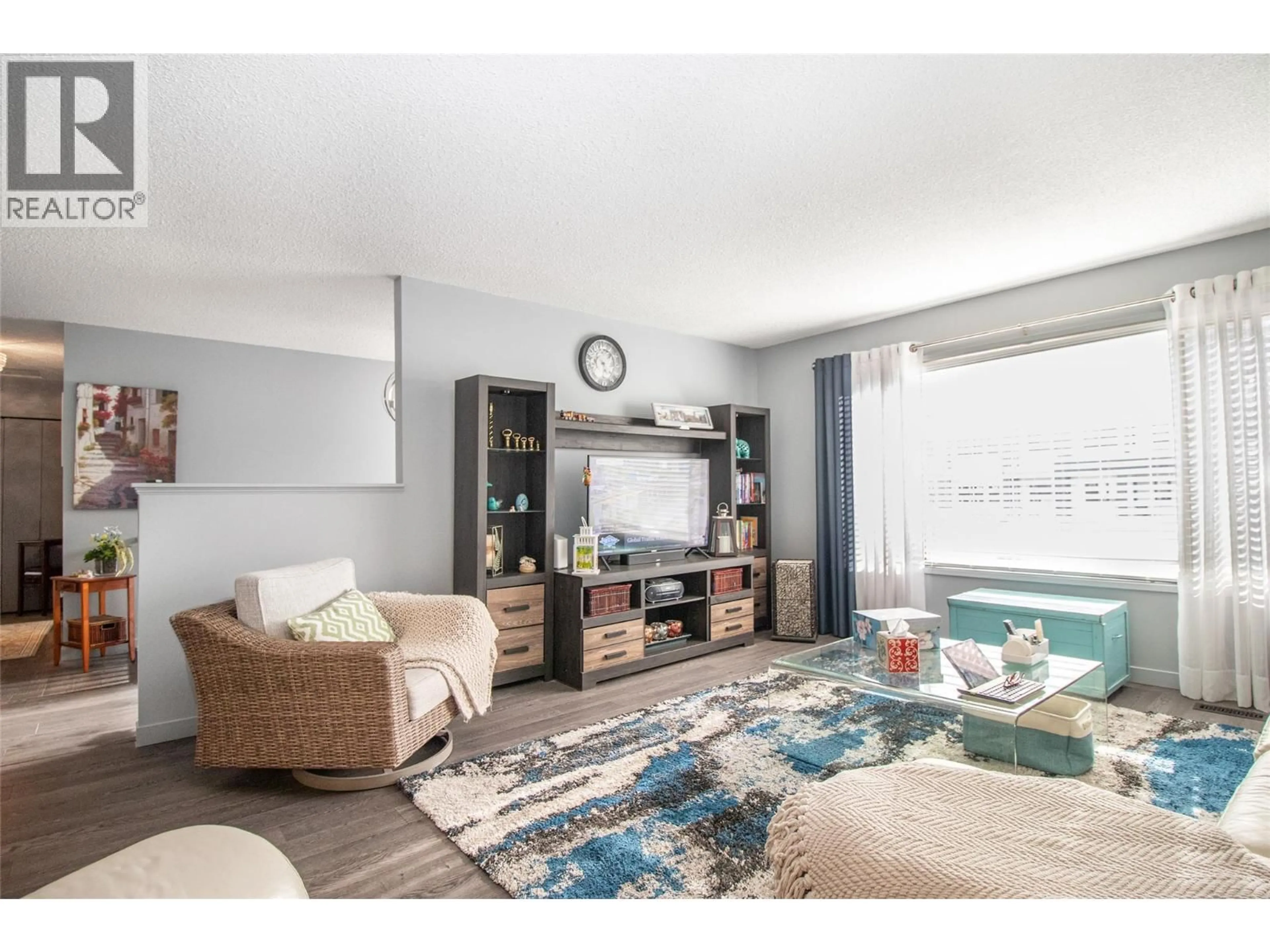 Living room with furniture, wood/laminate floor for 2111 WILKINSON STREET, Kelowna British Columbia V1Y4A1