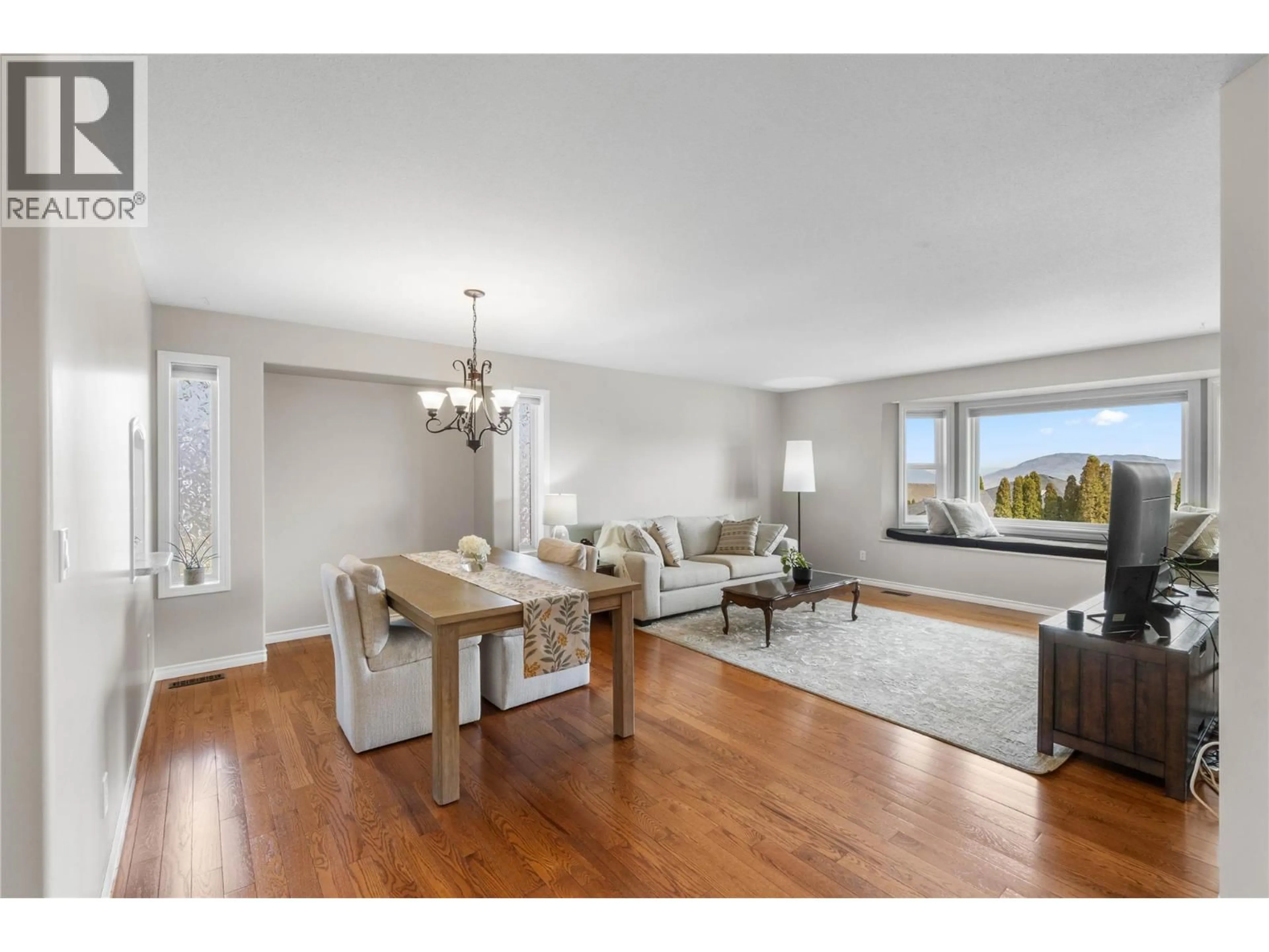Living room with furniture, wood/laminate floor for 2324 ABBEYGLEN WAY, Kamloops British Columbia V1S1V6