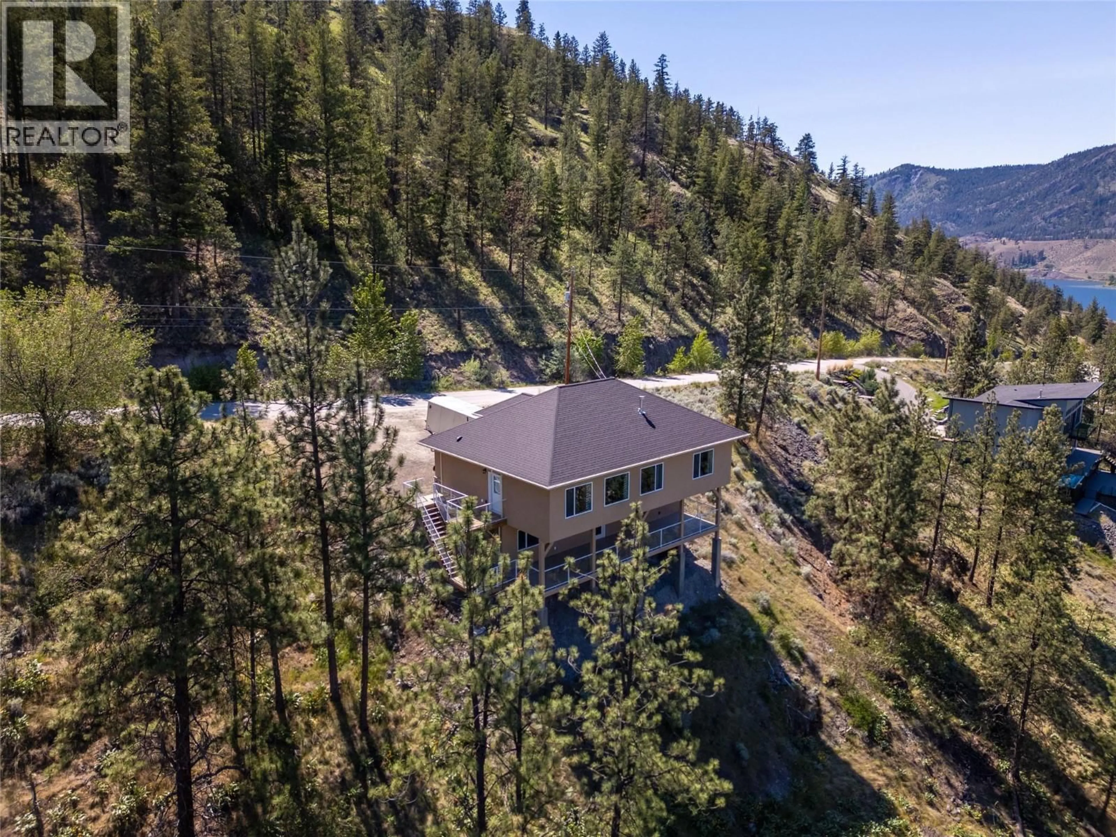 A pic from outside/outdoor area/front of a property/back of a property/a pic from drone, forest/trees view for 182 RACETTE WAY, Okanagan Falls British Columbia V0H1R5