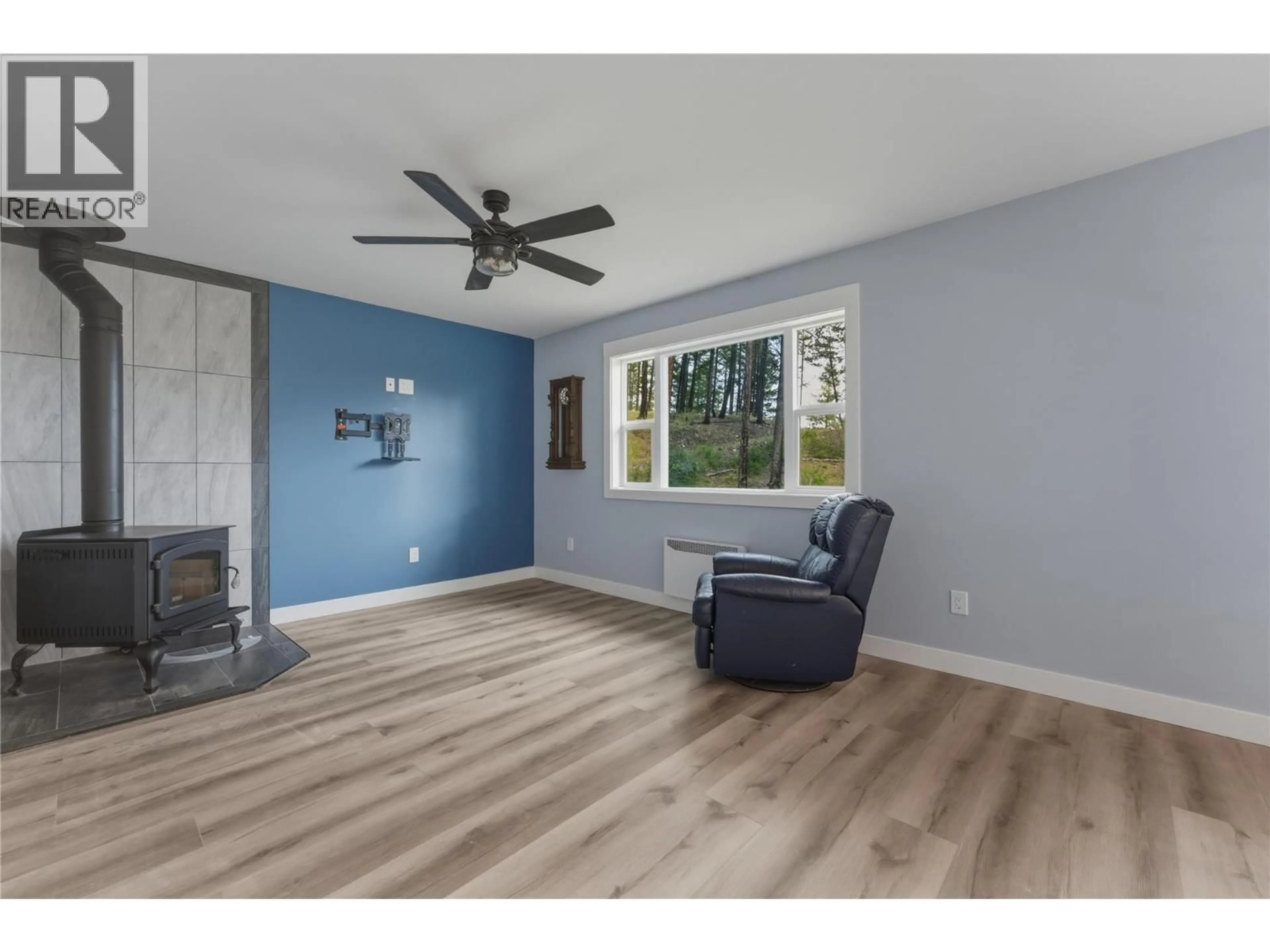 Living room with furniture, wood/laminate floor for 784 WOOD ROAD, Kelowna British Columbia V1Z3V6