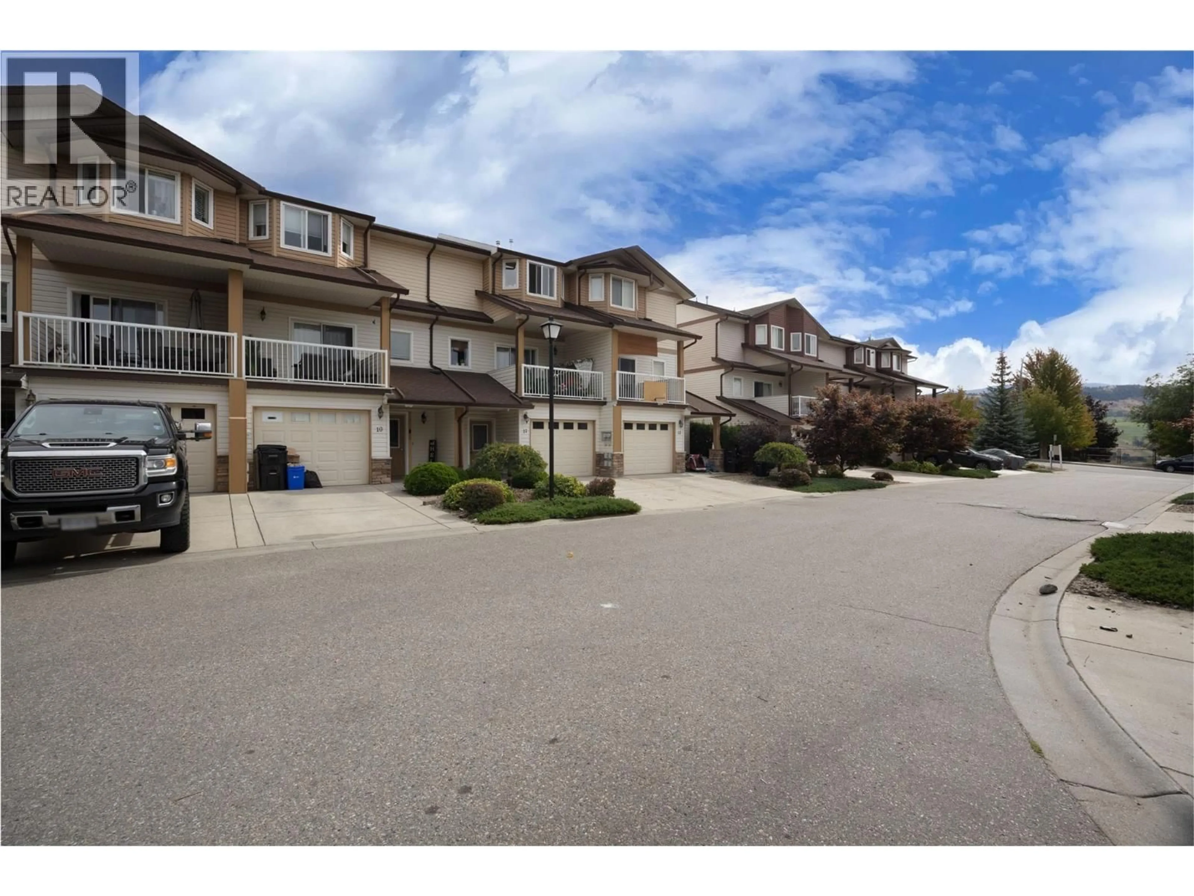 A pic from outside/outdoor area/front of a property/back of a property/a pic from drone, street for 10 - 5951 HERITAGE DRIVE, Vernon British Columbia V1H1Z5