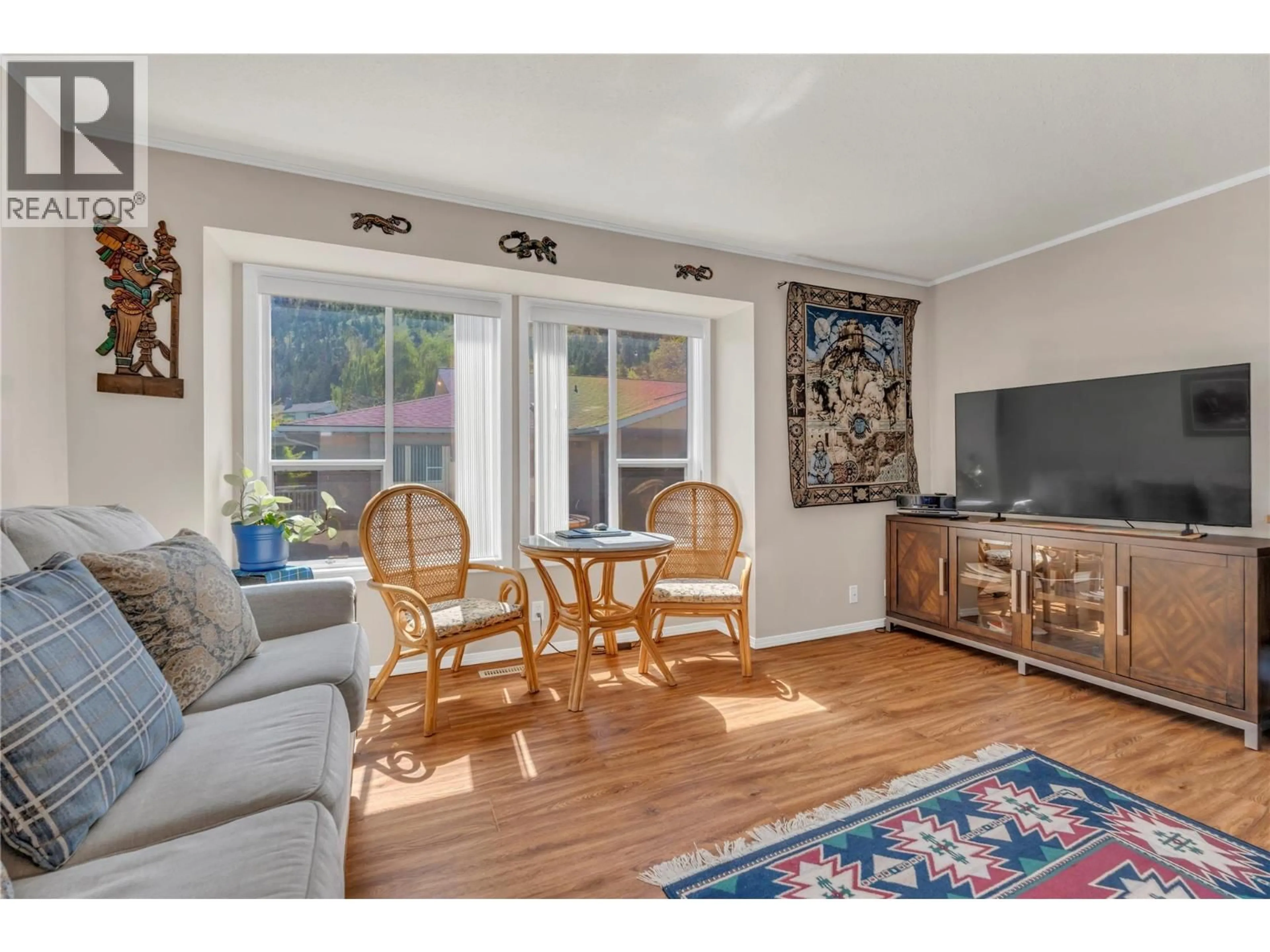 Living room with furniture, wood/laminate floor for 4 - 12606 TEMPLE COURT, Summerland British Columbia V0H1Z4