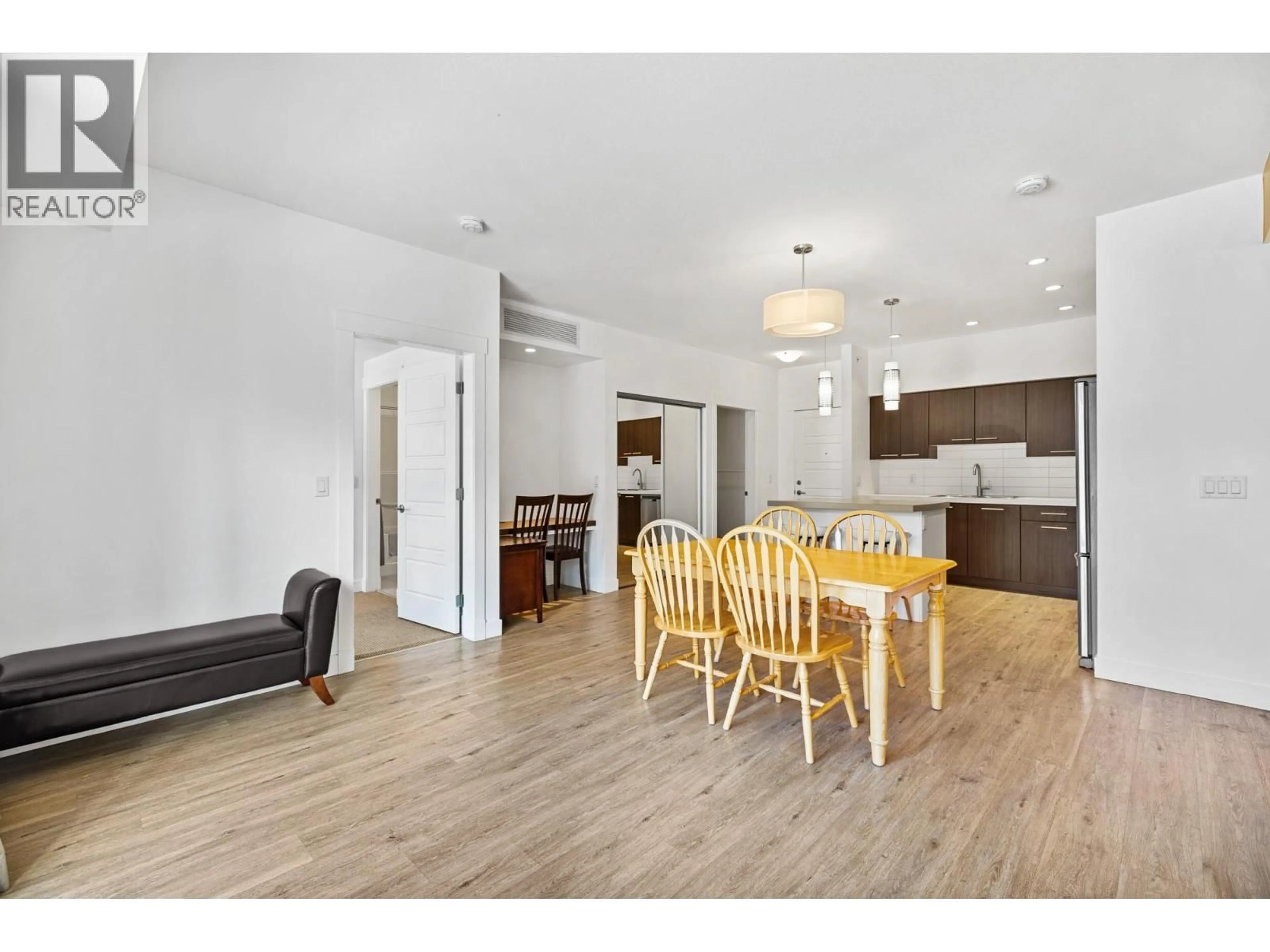 Open concept kitchen, wood/laminate floor for 308 - 985 ACADEMY WAY, Kelowna British Columbia V1V3C8