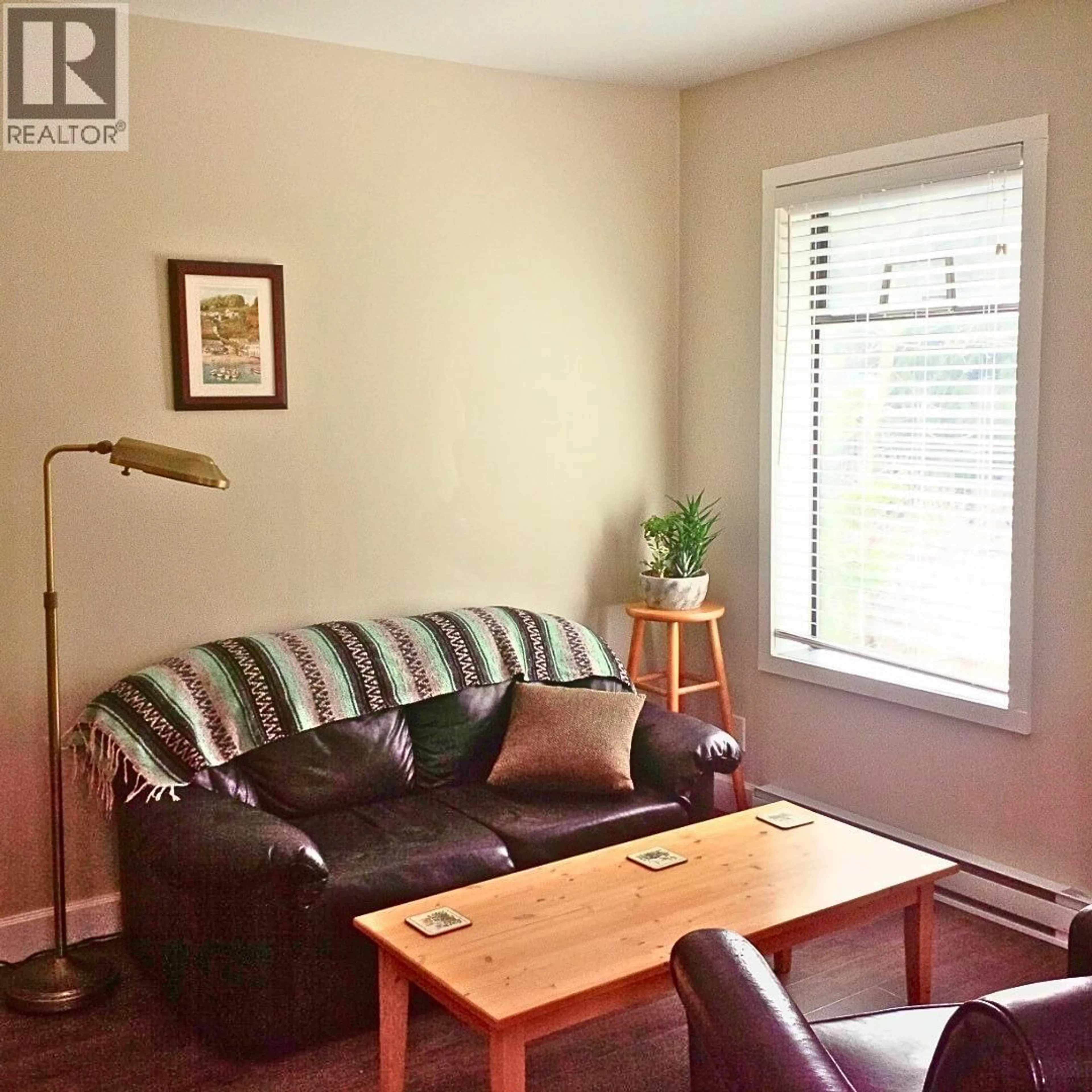 Living room with furniture, wood/laminate floor for 409 - 1510 NICKLEPLATE ROAD, Rossland British Columbia V0G1Y0