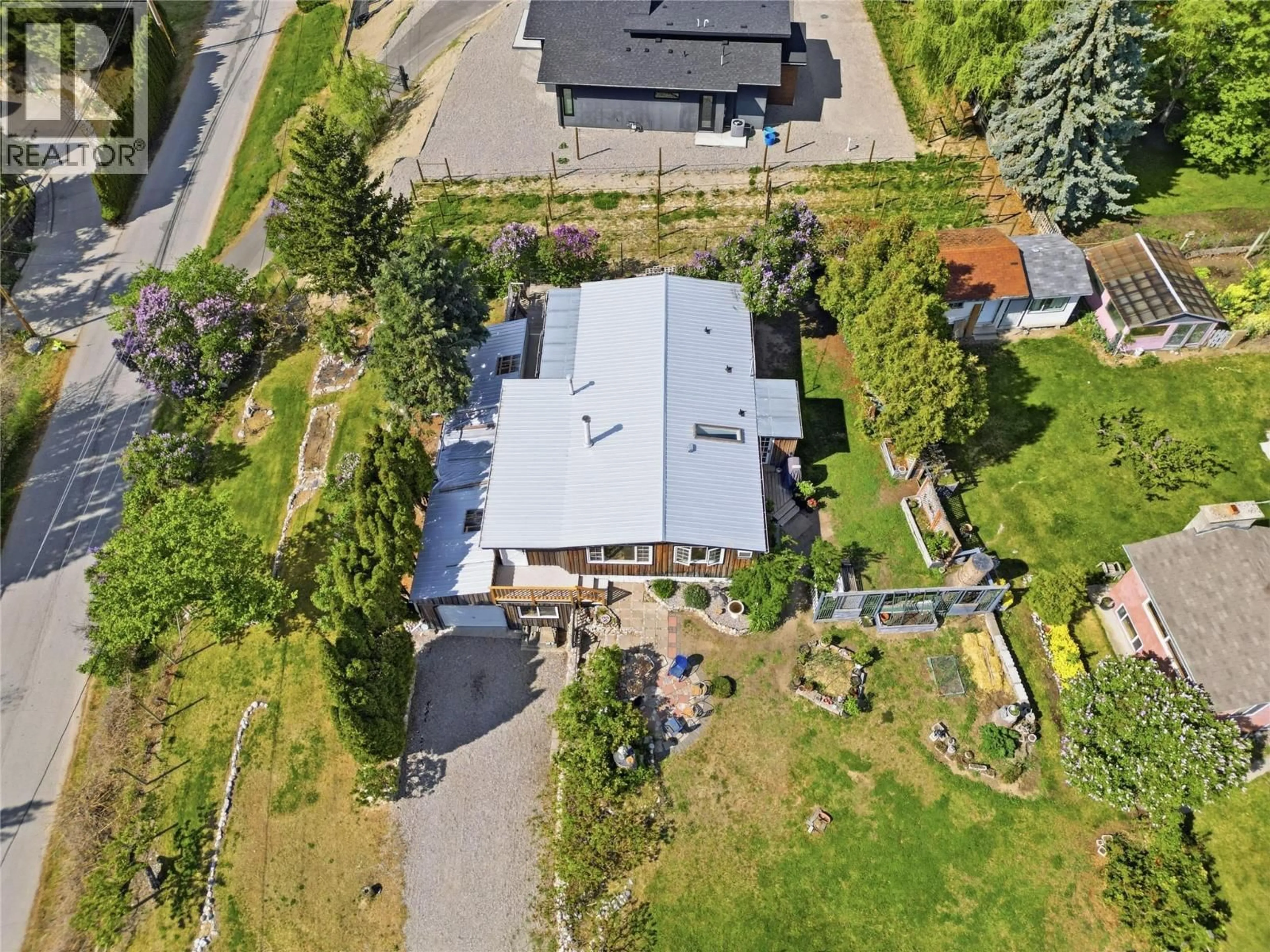 A pic from outside/outdoor area/front of a property/back of a property/a pic from drone, street for 905 LOWER DEBECK ROAD, Naramata British Columbia V0H1N1