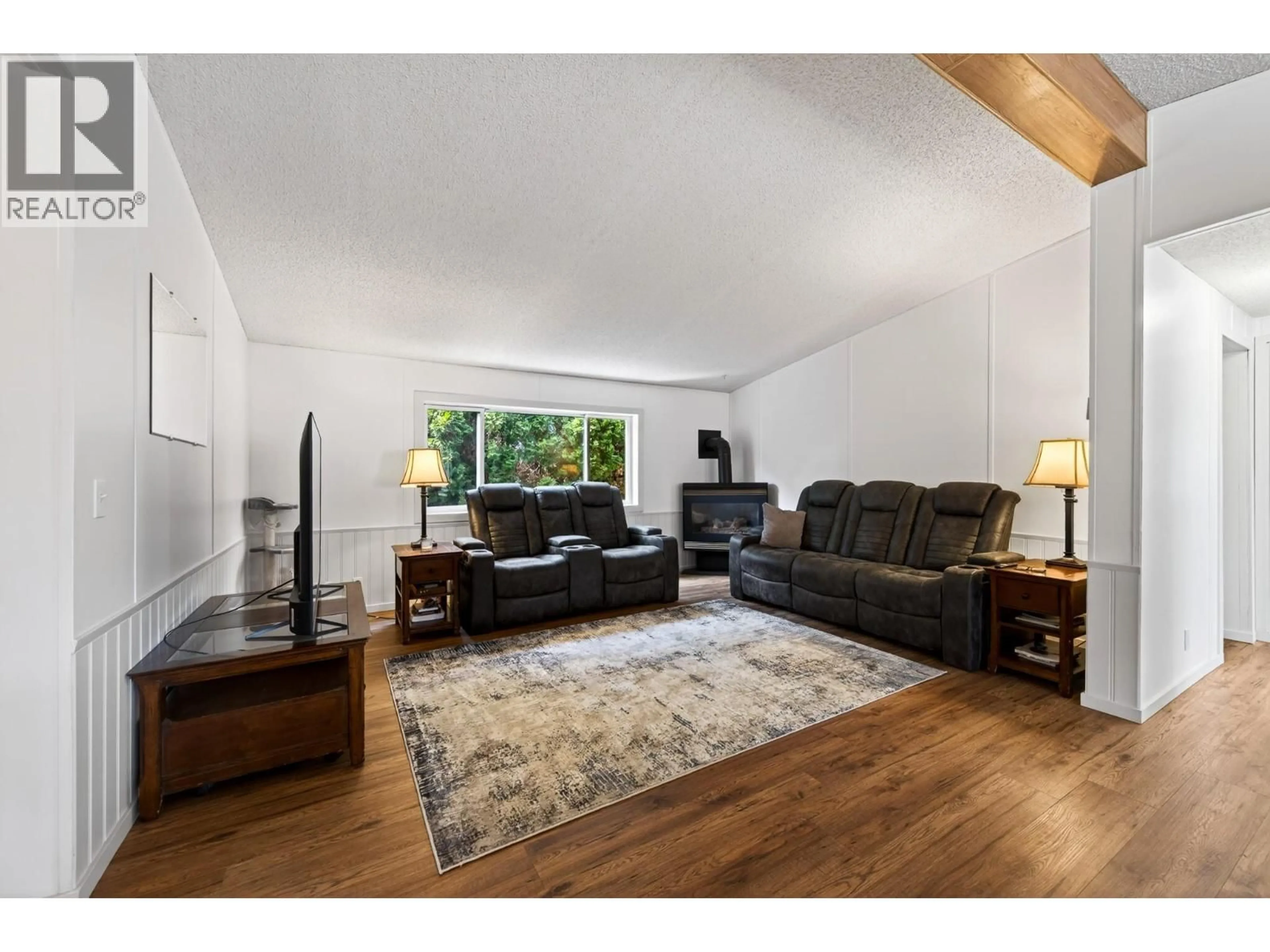 Living room with furniture, wood/laminate floor for 7070 WATSON DRIVE EAST, Kamloops British Columbia V0K2J0