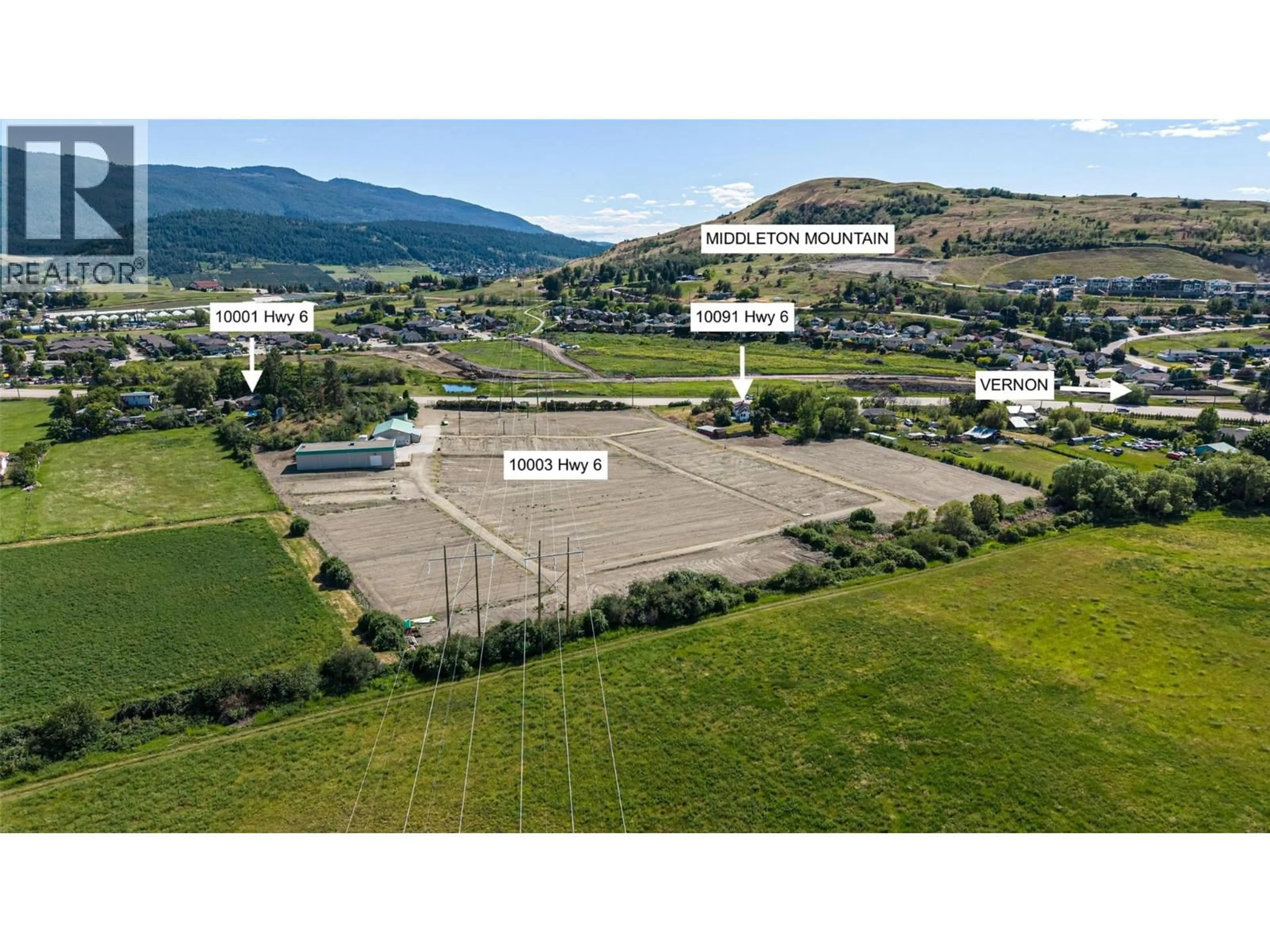 A pic from outside/outdoor area/front of a property/back of a property/a pic from drone, mountain view for 10003 6 HIGHWAY, Coldstream British Columbia V1B3B6