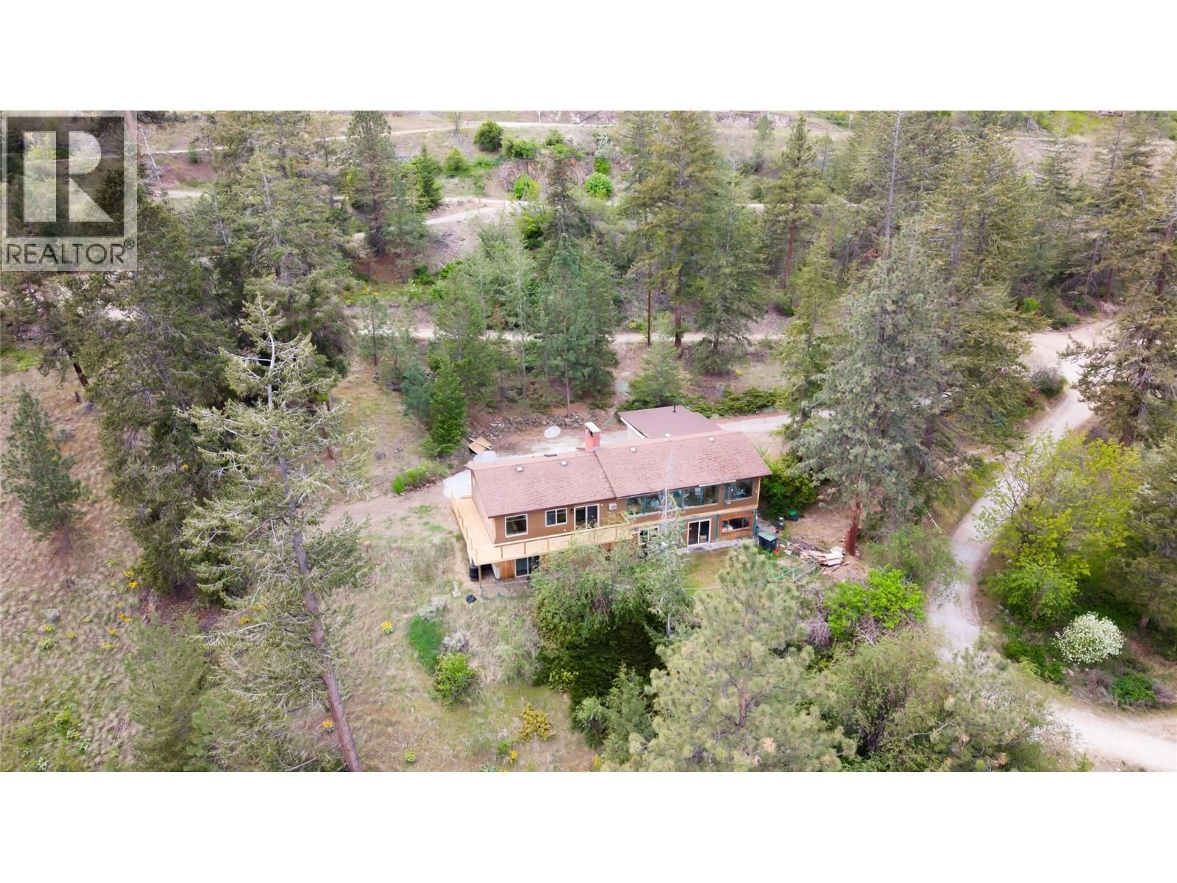 A pic from outside/outdoor area/front of a property/back of a property/a pic from drone, forest/trees view for 7260 HIGHWAY 97 OTHER SOUTH, Peachland British Columbia V0H1X9