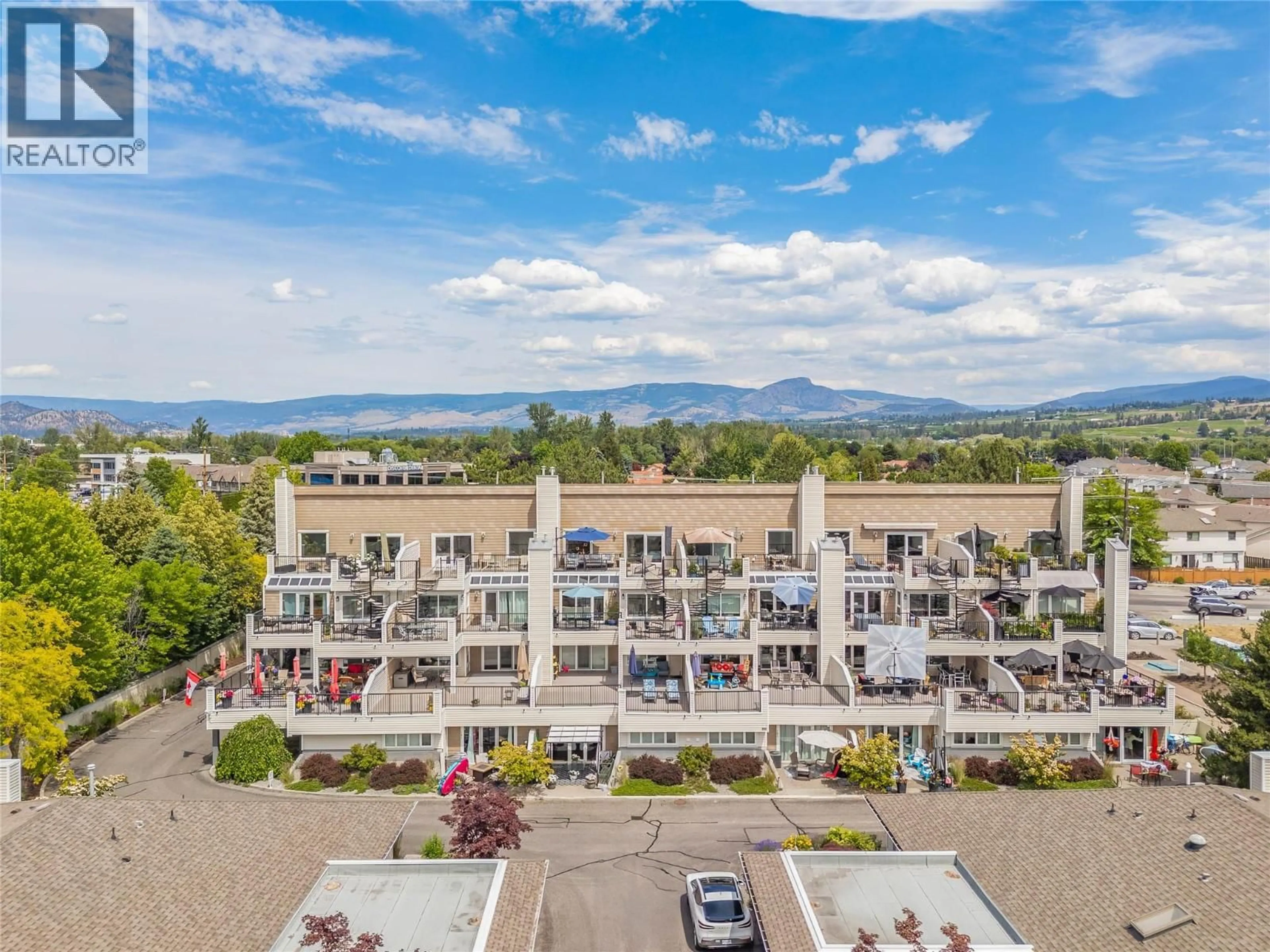 A pic from outside/outdoor area/front of a property/back of a property/a pic from drone, mountain view for 303 - 4004 BLUEBIRD ROAD, Kelowna British Columbia V1X1X6