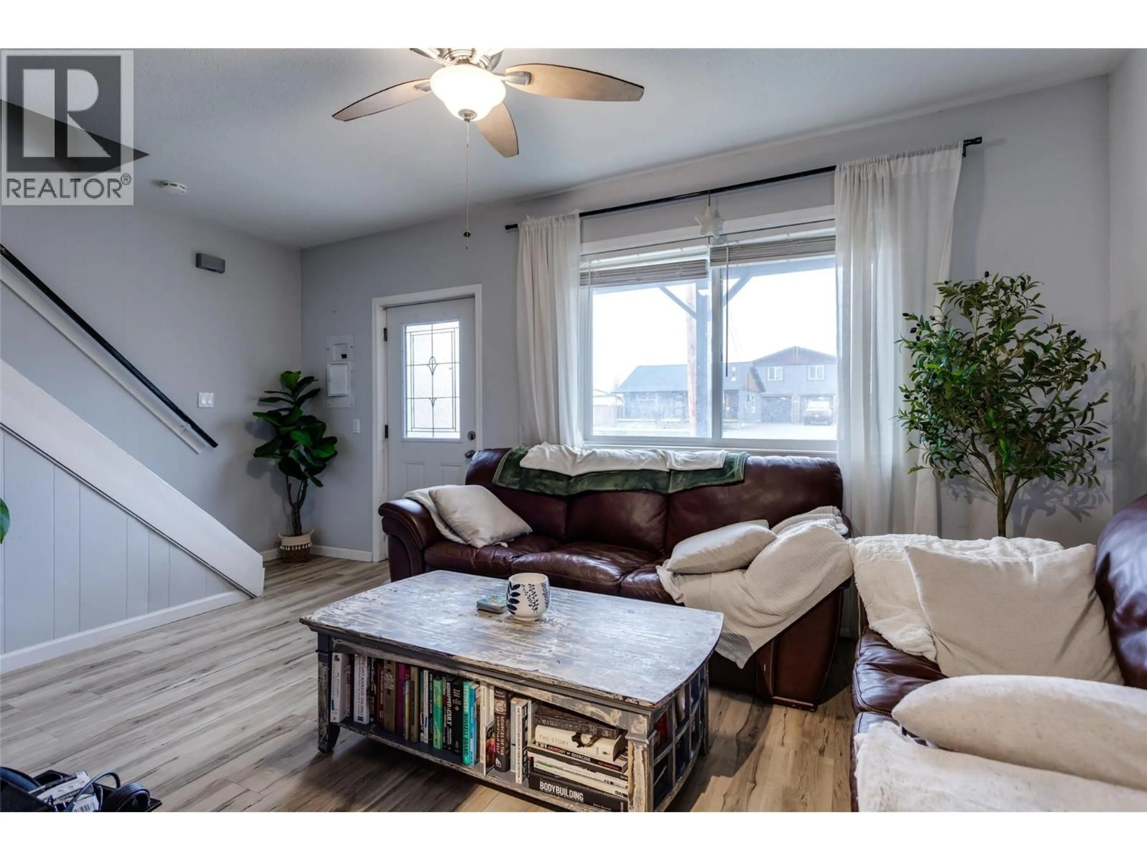 Living room with furniture, wood/laminate floor for 409 BAIRD AVENUE, Enderby British Columbia V4Y4A2