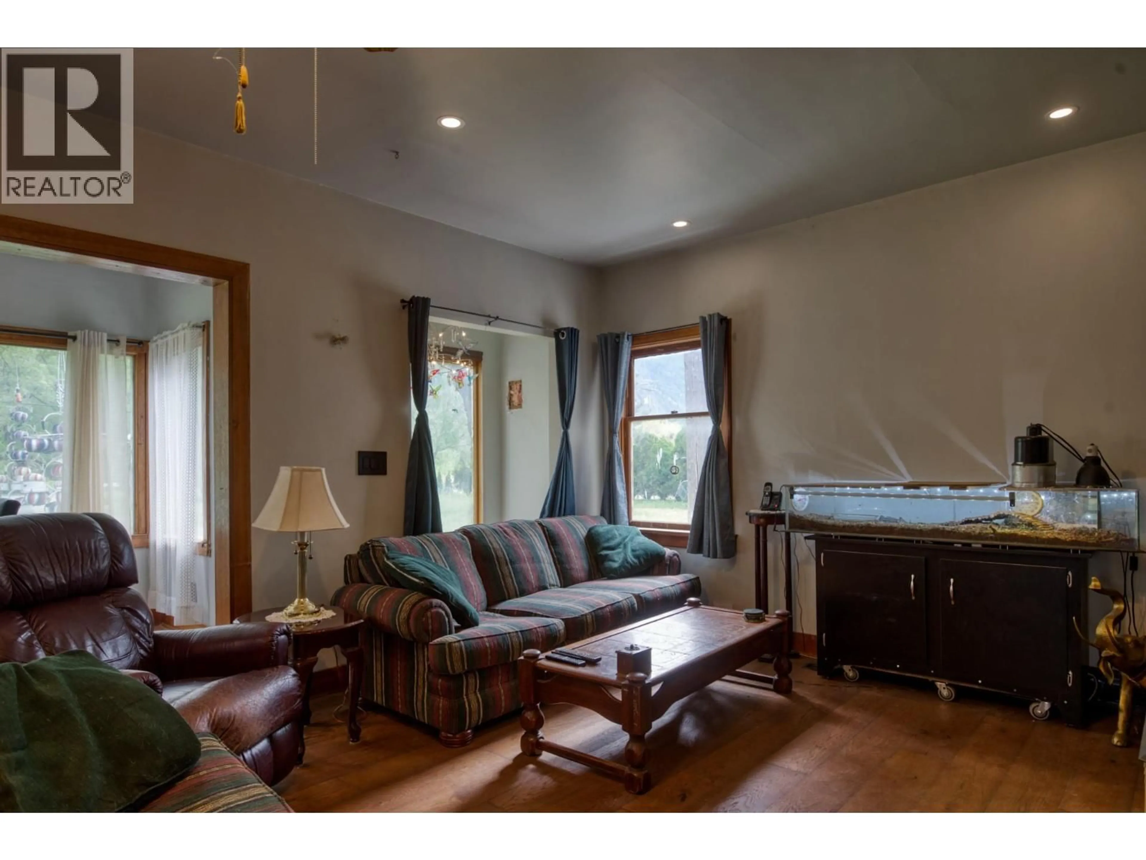 Living room with furniture, wood/laminate floor for 3038 10TH AVENUE, Keremeos British Columbia V0X1N3