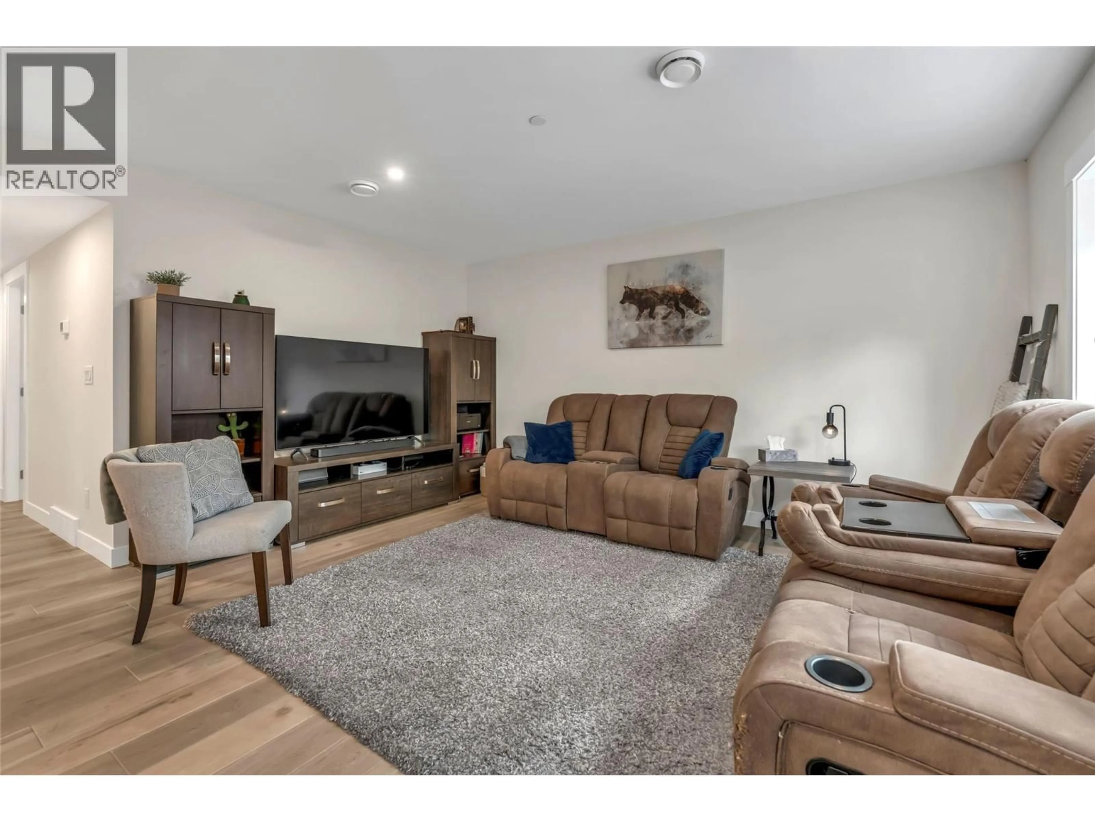 Living room with furniture, wood/laminate floor for 102 - 241 NELSON AVENUE, Penticton British Columbia V2A2L1