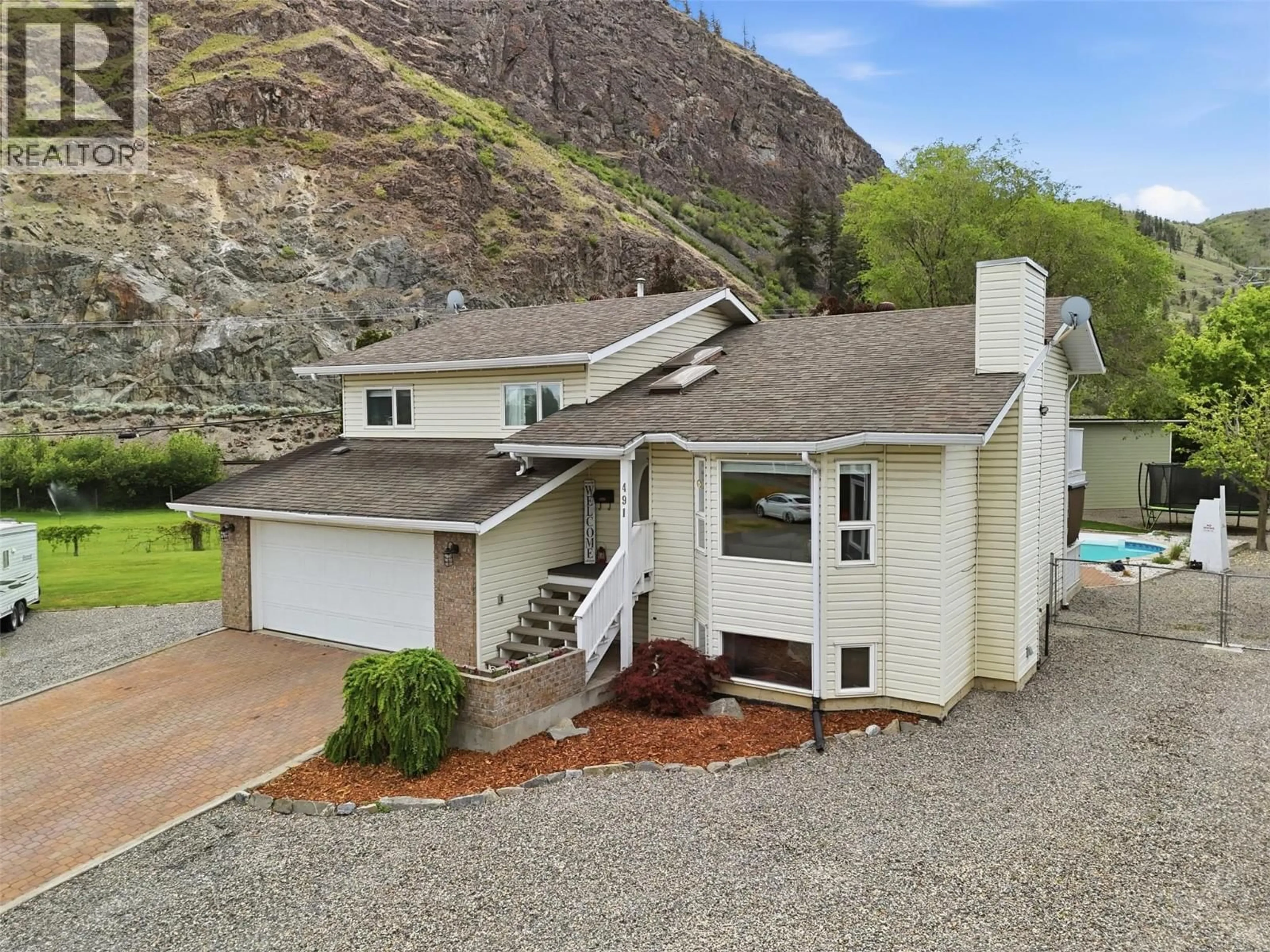 A pic from outside/outdoor area/front of a property/back of a property/a pic from drone, mountain view for 491 CHILCO AVENUE, Kamloops British Columbia V2H1L9
