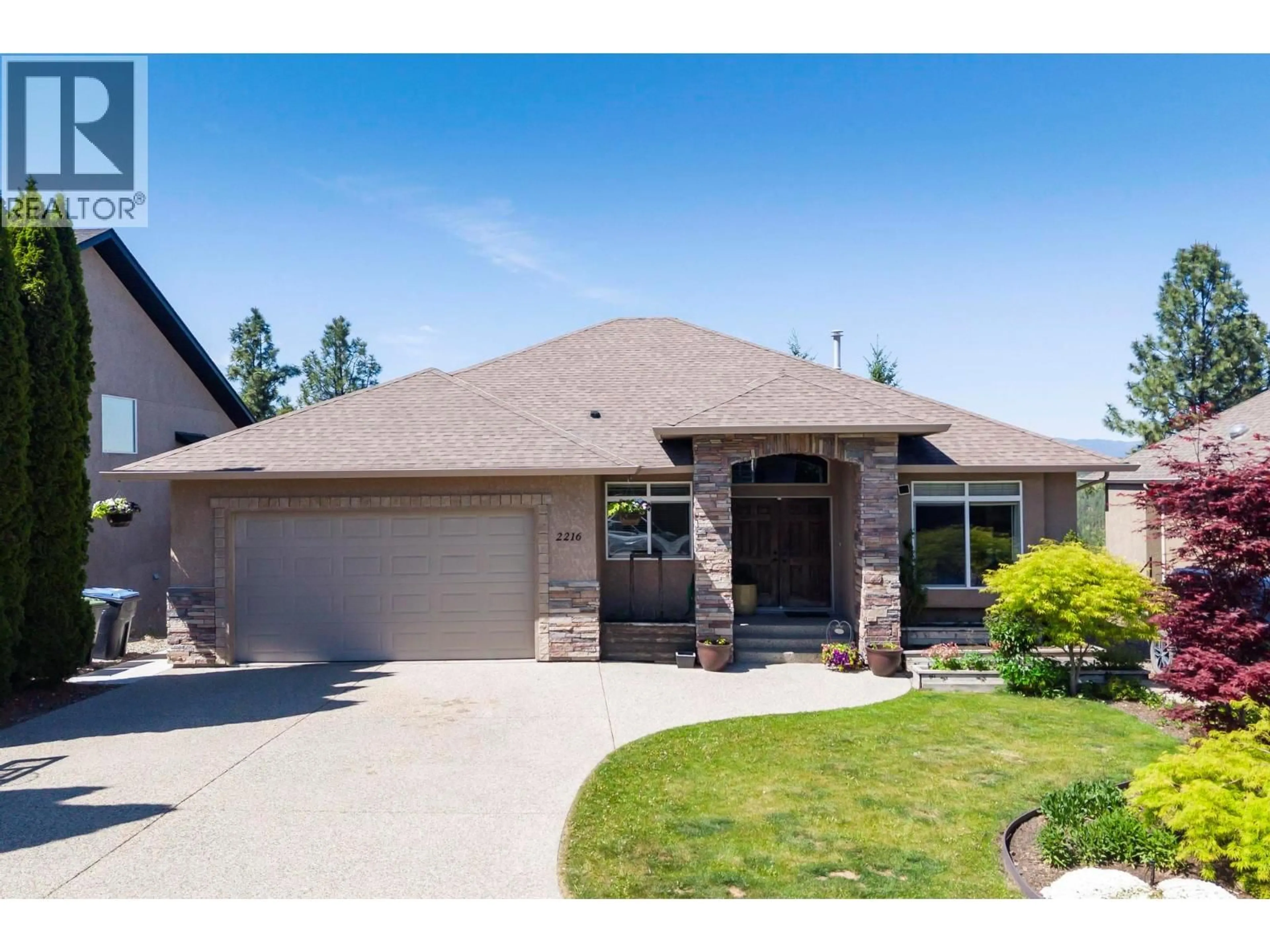 Home with brick exterior material, street for 2216 QUAIL RUN DRIVE, Kelowna British Columbia V1V2S4