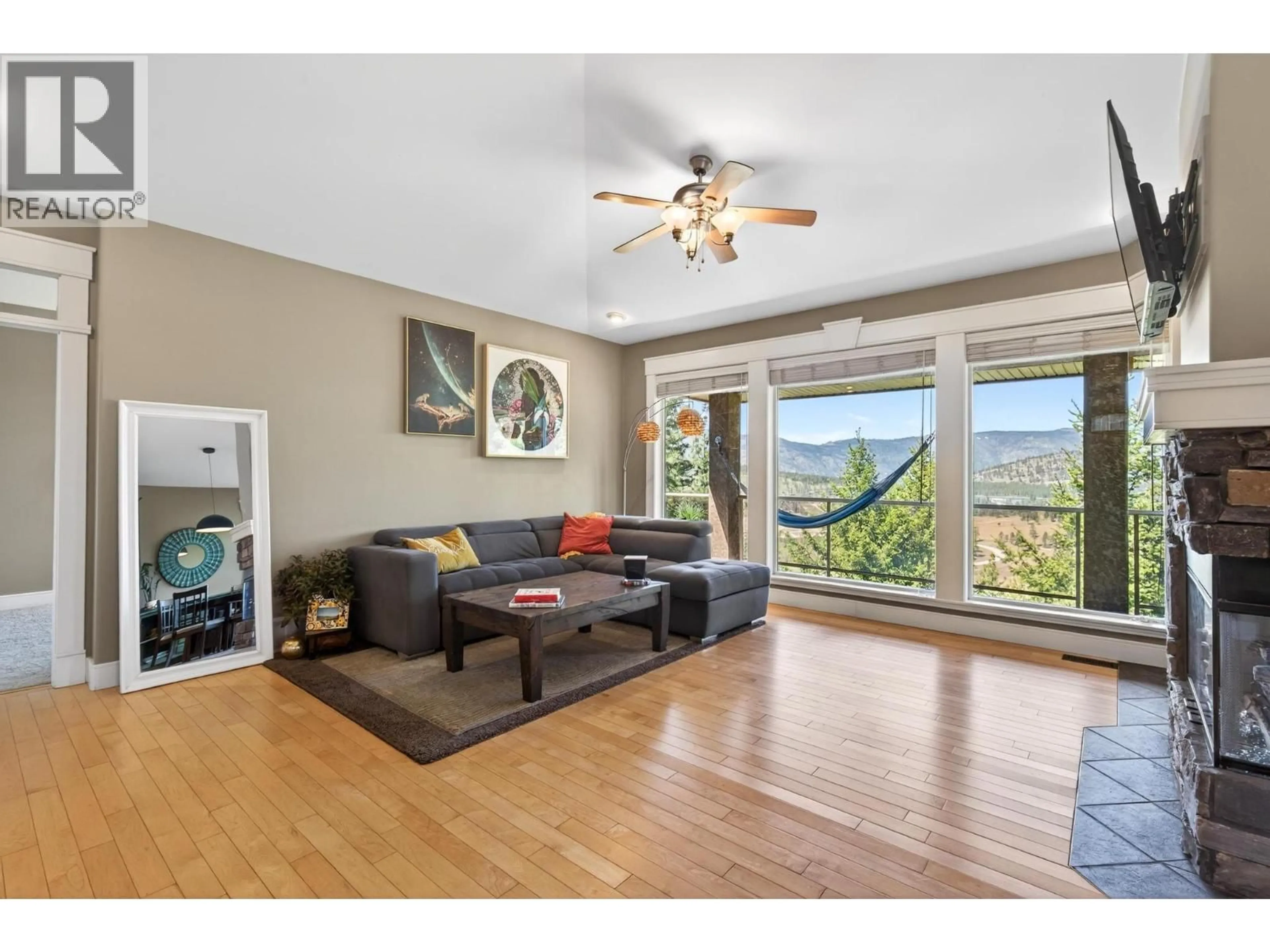 Living room with furniture, wood/laminate floor for 2216 QUAIL RUN DRIVE, Kelowna British Columbia V1V2S4