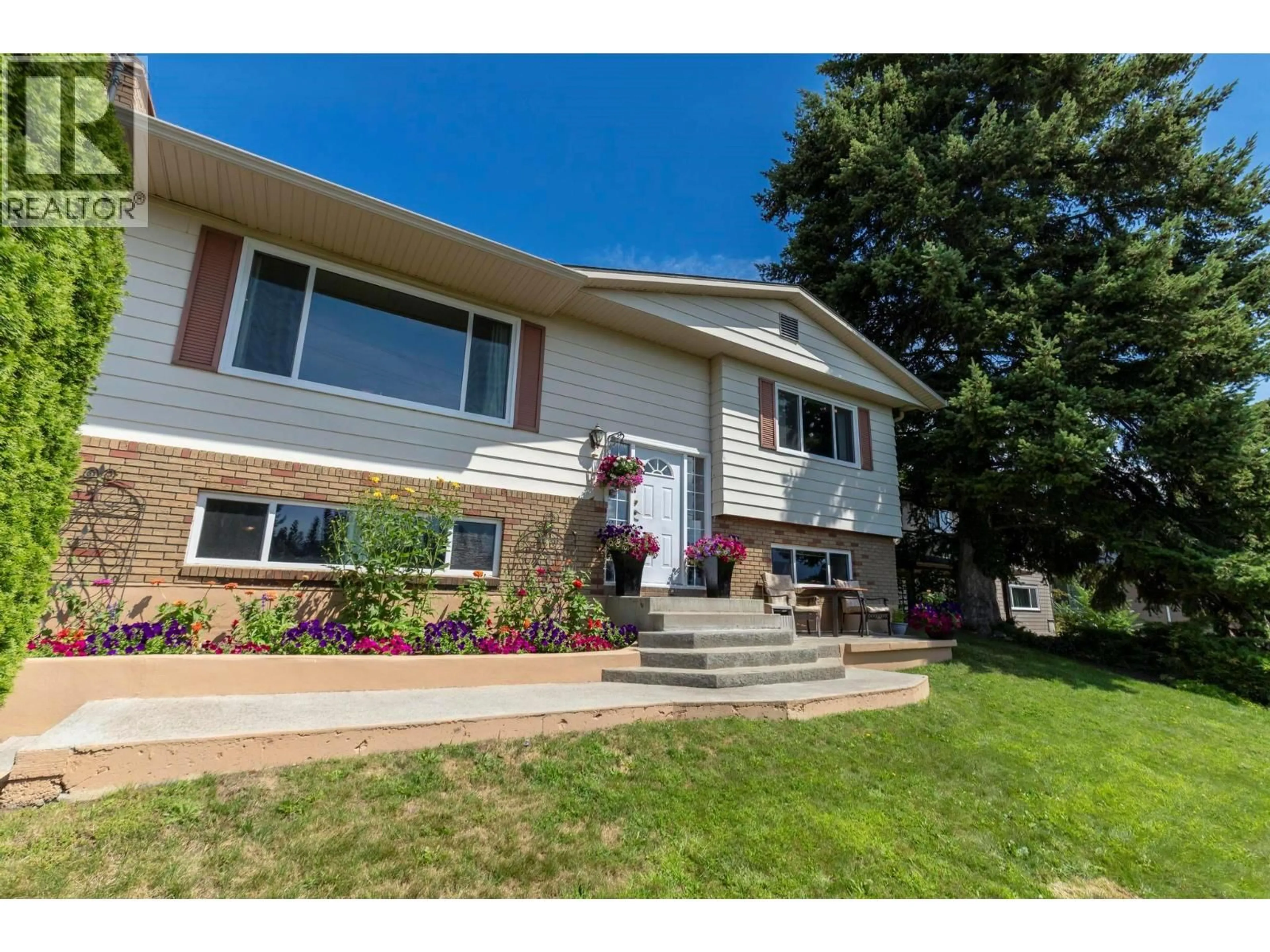 Home with vinyl exterior material, street for 1285 BEGLEY ROAD, Kelowna British Columbia V1P1K8